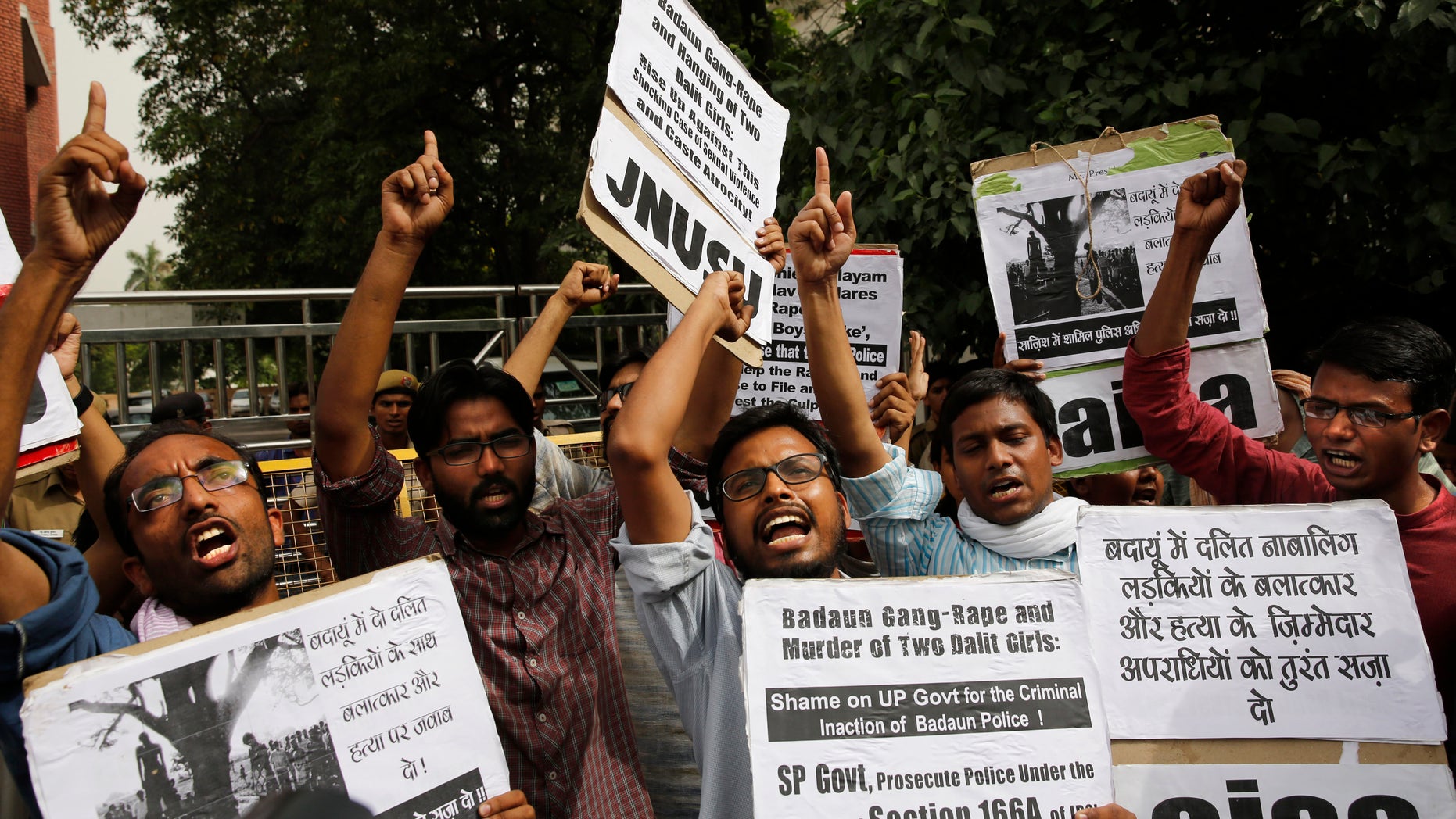 May 30, 2014 - Members of Jawaharlal Nehru University Students Union shout slogans during a protest against a gang rape of two teenage girls in Katra village, outside a statehouse in New Delhi, India. A top government official said the Uttar Pradesh state fired 2 police officers who failed to respond to a complaint by the father of the 2 teenage girls who went missing and were later found gang raped and killed. Sign at right reads "Punish the culprits of gang-rape and murder of two Dalit girls."