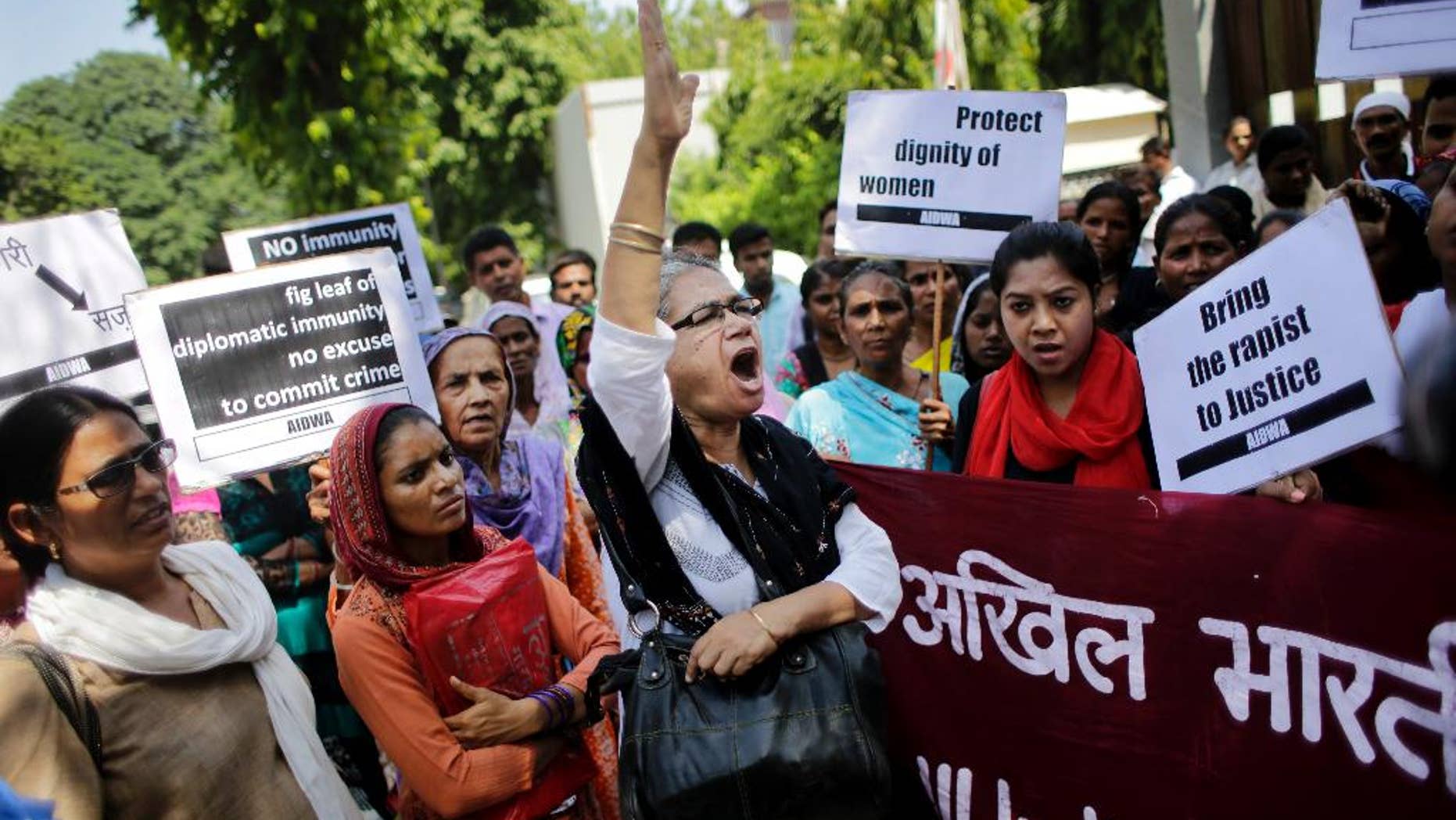 FILE - In this Thursday, Sept. 10, 2015 file photo, activists of All India Democratic Women's Association shout slogans during a protest outside the Saudi Arabian embassy in New Delhi, India. Indian officials say a Saudi Arabian diplomat accused of repeatedly raping and abusing two women has left India under the cover of diplomatic immunity. (AP Photo/Altaf Qadri, File)