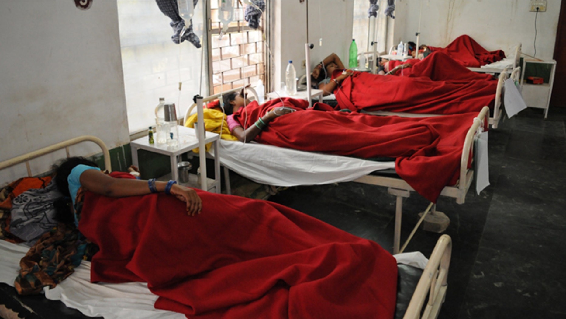 November 12, 2014: Indian women who underwent sterilization surgeries receive treatment at the District Hospital in Bilaspur, in the central Indian state of Chhattisgarh, after at least a dozen died and many others fell ill following similar surgery. (AP Photo)