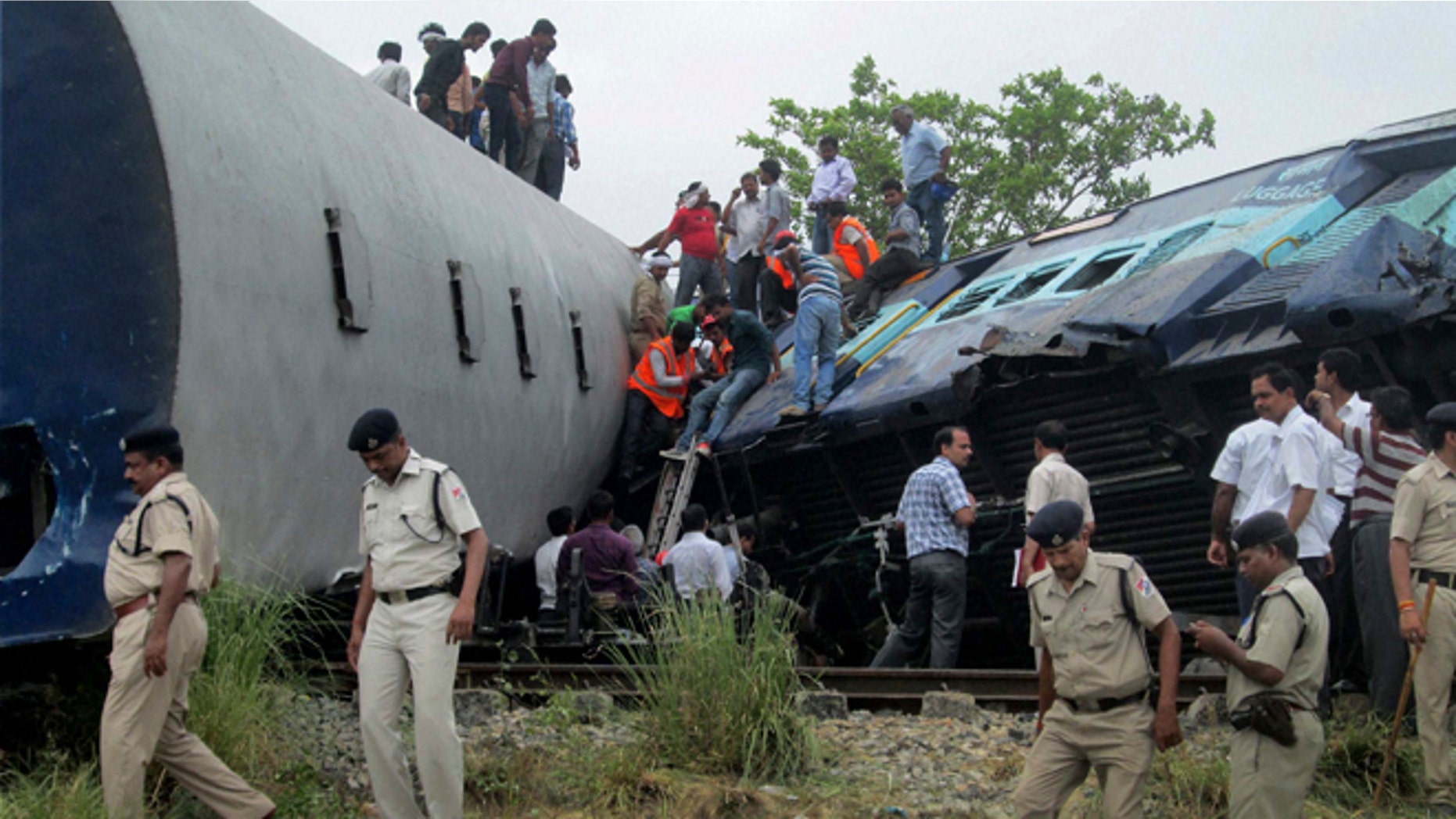 May 26, 2014: Indian officials and rescuers gather around the wreckage after the Gorakhpur Express passenger train slammed into a parked freight train Chureb, near Basti, Uttar Pradesh state, India. (AP)