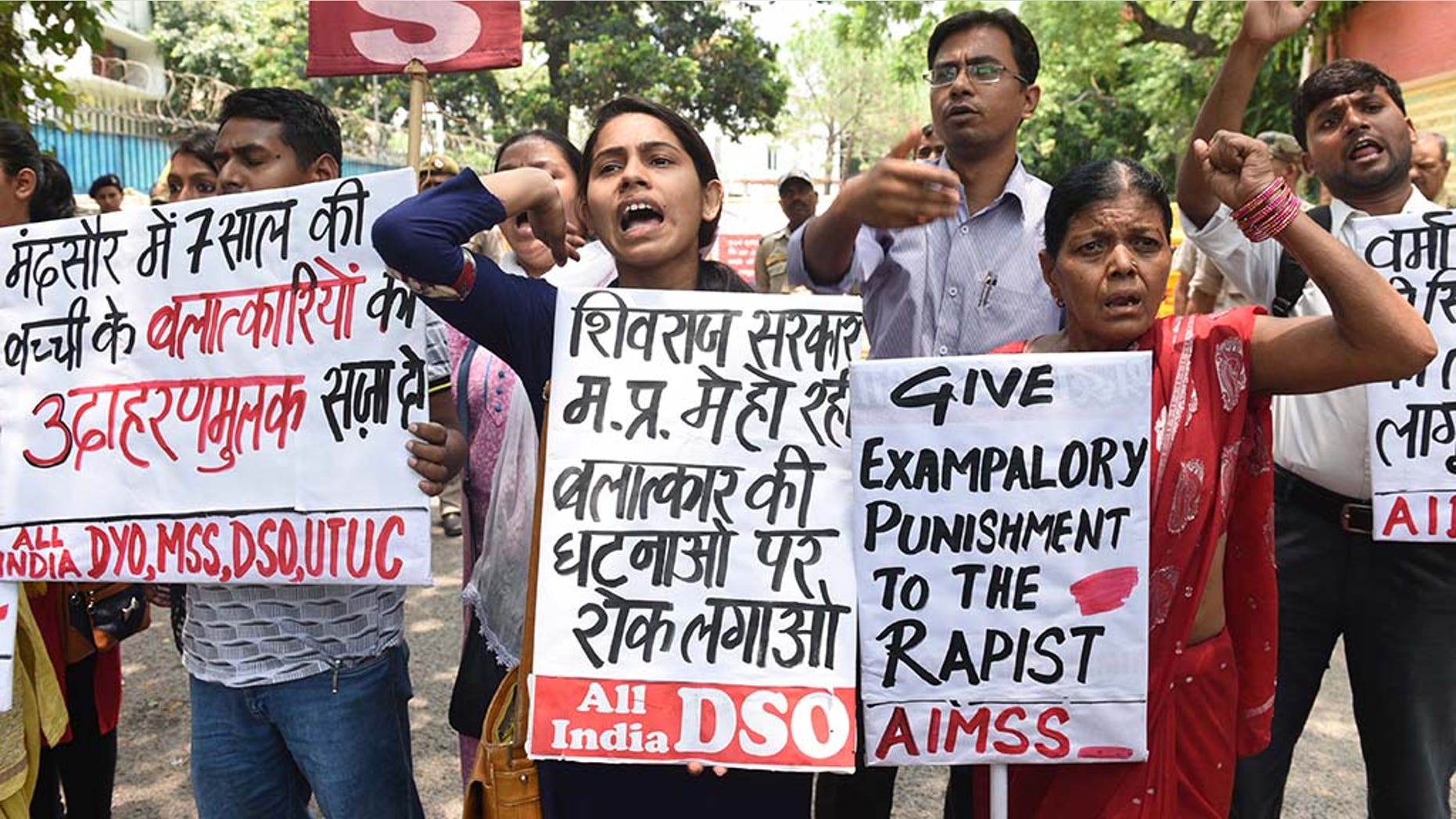 NEW DELHI, INDIA - JUNE 30: Member of AIMSS, AIDSO, AIDYO hold placards and shout slogans during a protest against the brutal rape of a seven-year-old girl in Mandsaur, Madhya Pradesh, at Madhya Pradesh House, Chanakyapuri, on June 30, 2018 in New Delhi, India. (Photo by Sonu Mehta/Hindustan Times via Getty Images)