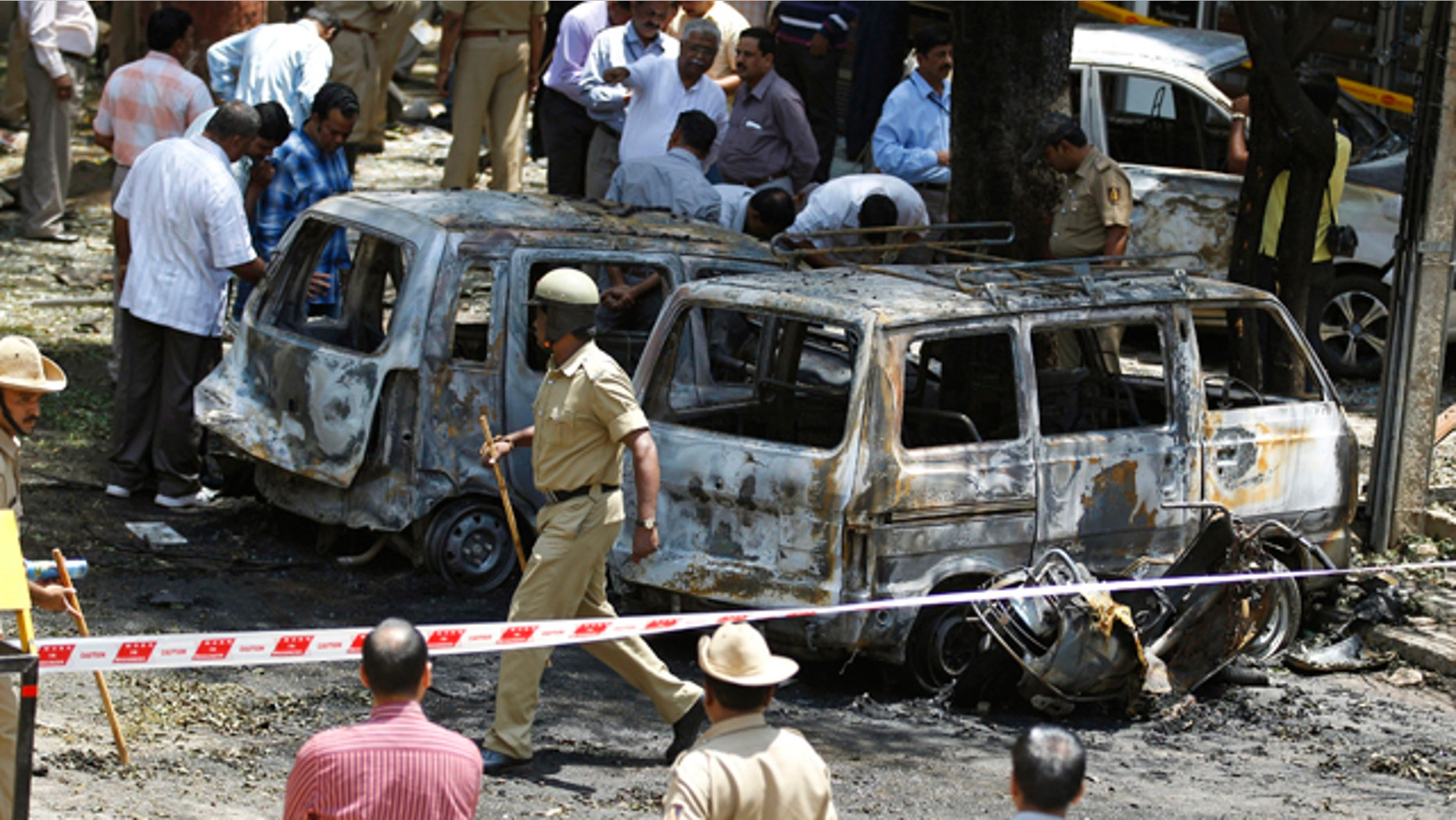 April 17, 2013: Policemen and officials inspect the site of an explosion at a residential neighborhood near the office of India's main opposition Bharatiya Janata Party in Bangalore, India.
