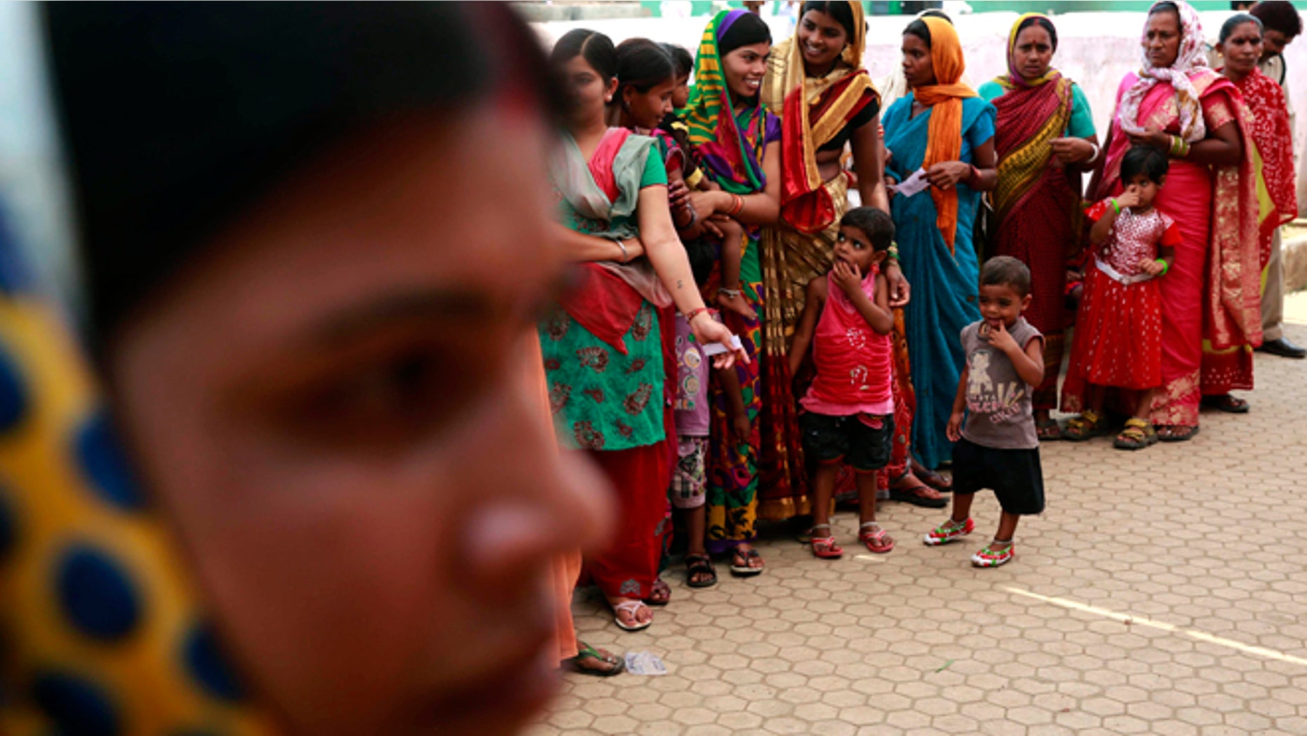 April 17, 2014: Indian women stand in a queue to cast their votes in Rajnandgaon, in the central Indian state of Chhattisgarh, now the center of India's four-decade Maoist insurgency.