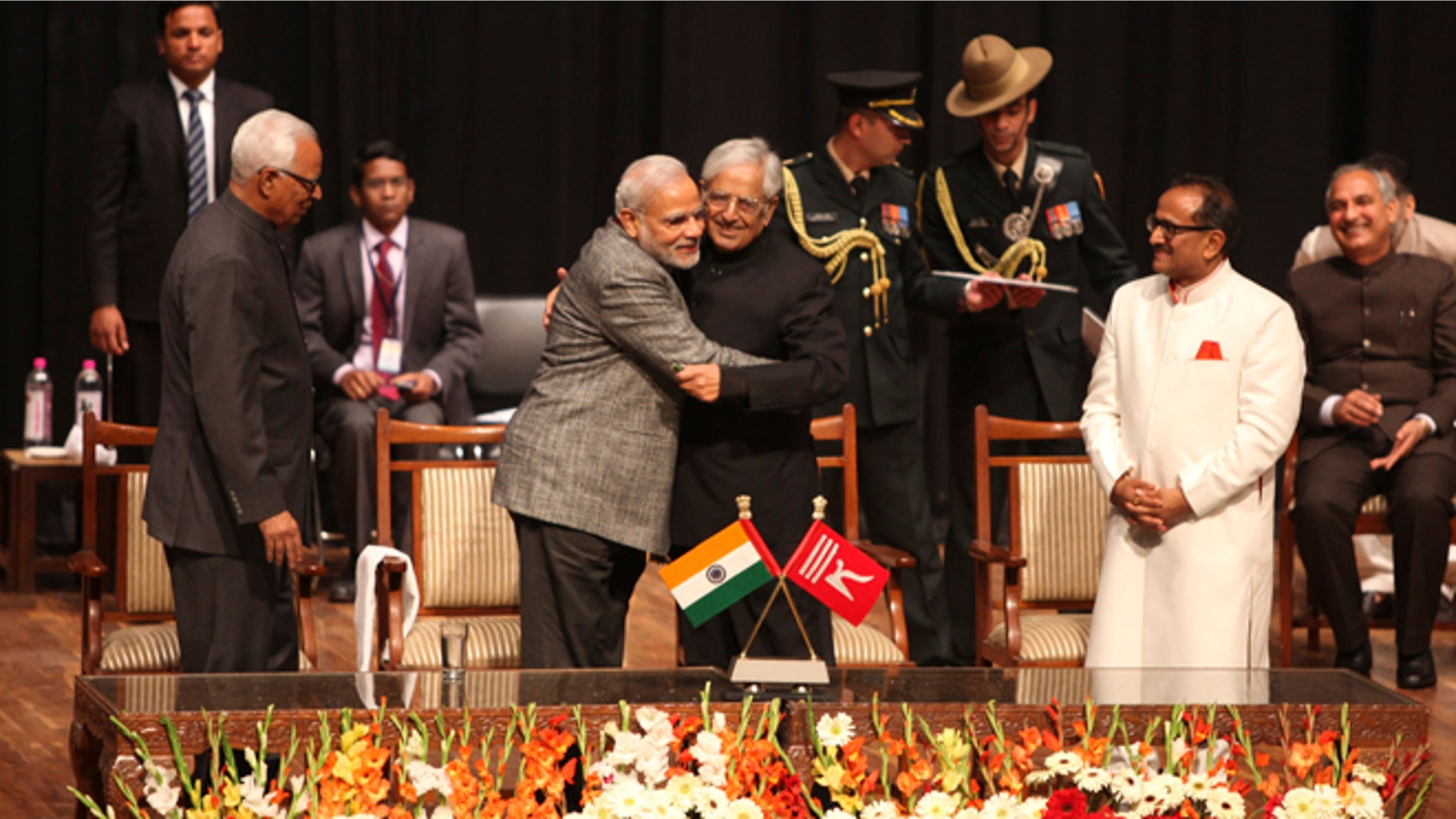 March 1, 2015: Indian Prime Minister Narendra Modi, center left, greets Peoples Democratic Party Mufti Mohammed Sayeed after the later was sworn in as the chief minister of Jammu and Kashmir state in Jammu, India. (AP)