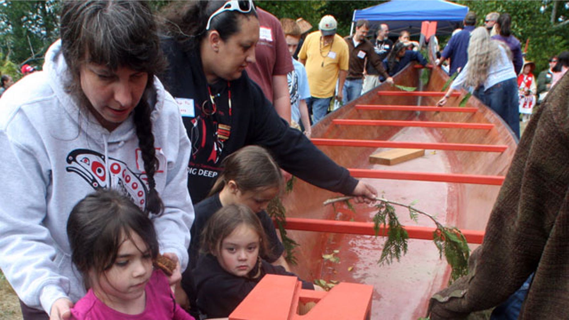 September 24: Mylee Wahlgren, 6, left, and her grandmother Donna Sinclair, of Washougal, Wash., bless the 36-foot replica canoe during the canoe reparation ceremony at Fort Columbia, near Chinook, Wash.