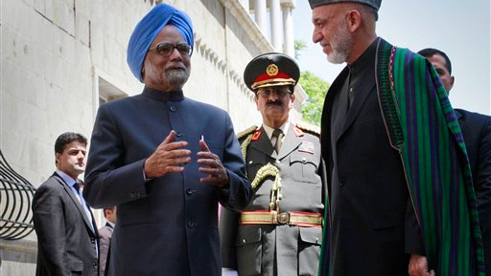 May 12: Indian Prime Minister Manmohan Singh speaks to the media, as Afghan President Hamid Karzai listens to him at the presidential palace in Kabul, Afghanistan.
