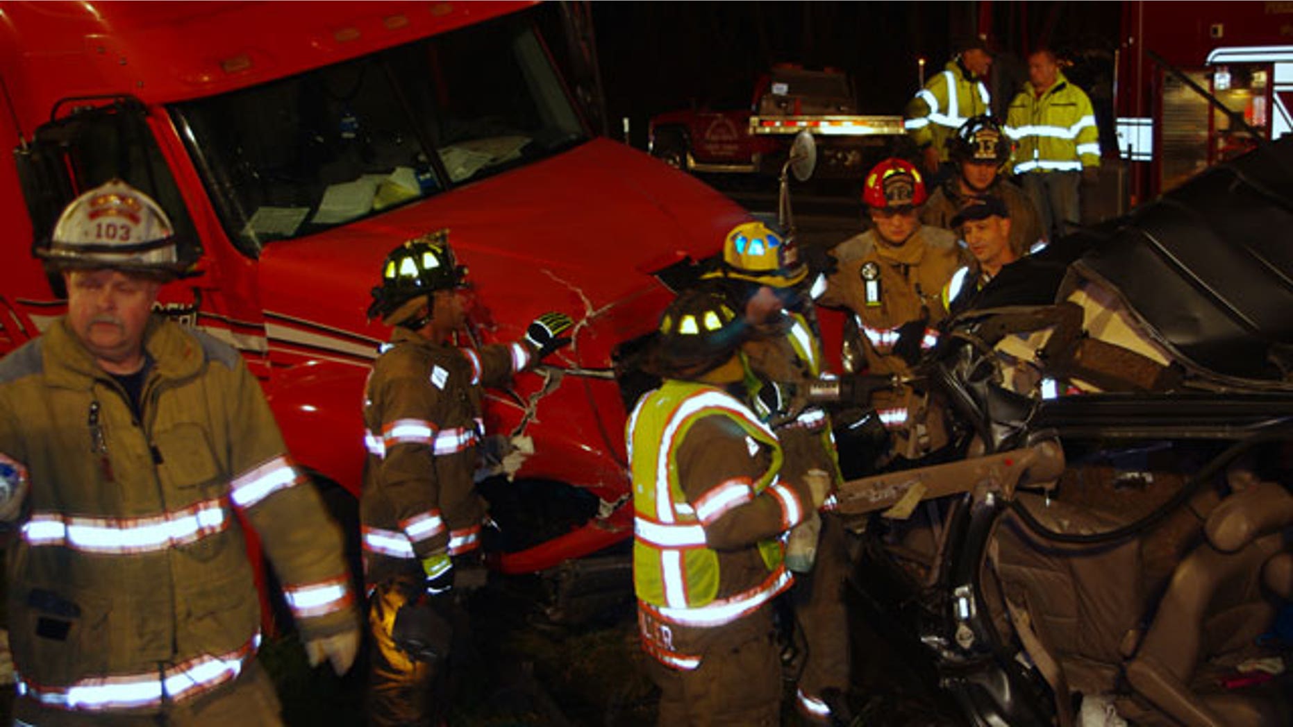 October 27, 2011: A photo released by the Indiana State Police shows firemen surveying the wreckage of a fatal accident on the Indiana Toll Road near Bristol, Ind.