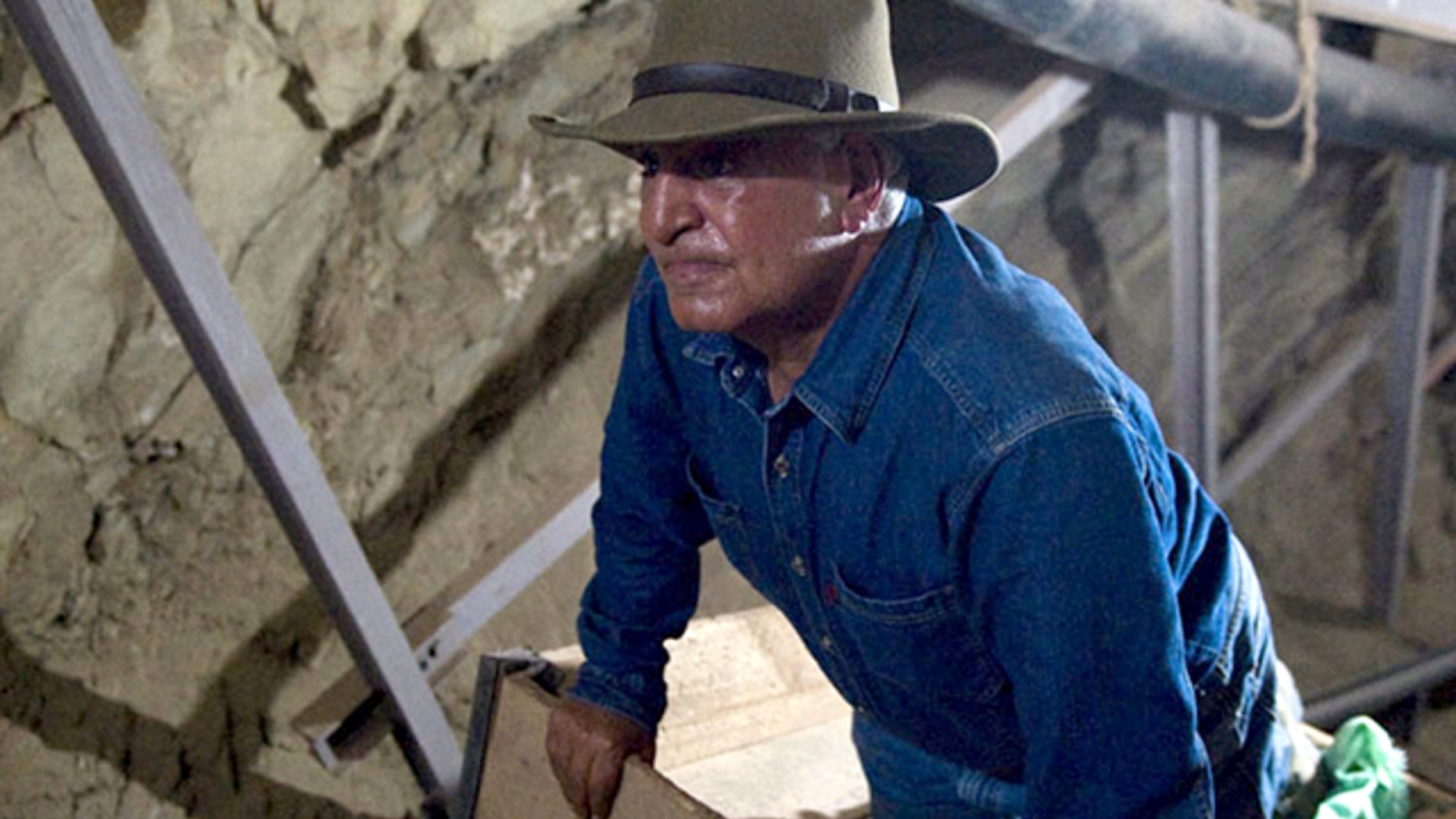 June 30, 2010: Looking for all the world like Indiana Jones, antiquities chief Zahi Hawass studies an unfinished 570-foot long tunnel in Luxor, Egypt -- first discovered in 1960 and possibly meant to be a secret tomb.