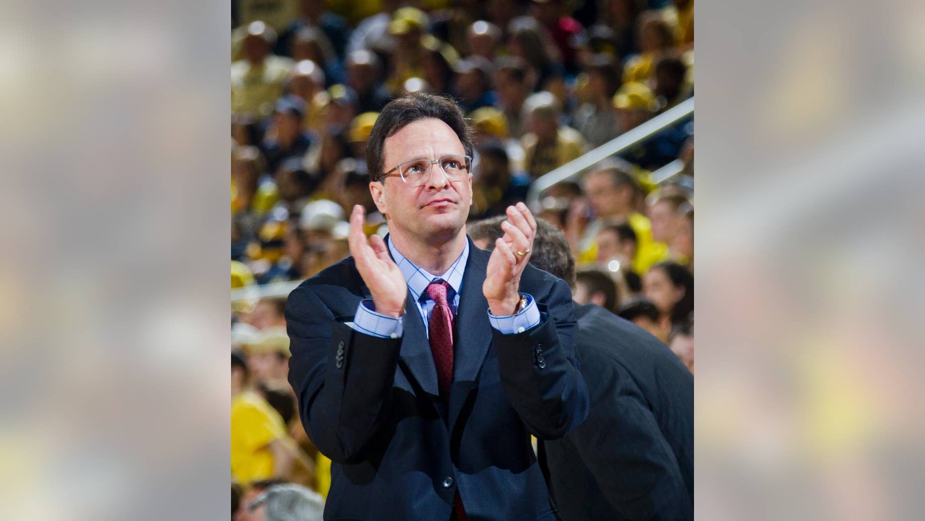 FILE - In this March 8, 2014, file photo, Indiana head coach Tom Crean claps his hands courtside in the second half of an NCAA college basketball game against Michigan at Crisler Center in Ann Arbor, Mich. Nearly eight months after the stunning conclusion to a mediocre season, the Hoosiers have made an attitude adjustment that could change everything.(AP Photo/Tony Ding, File)