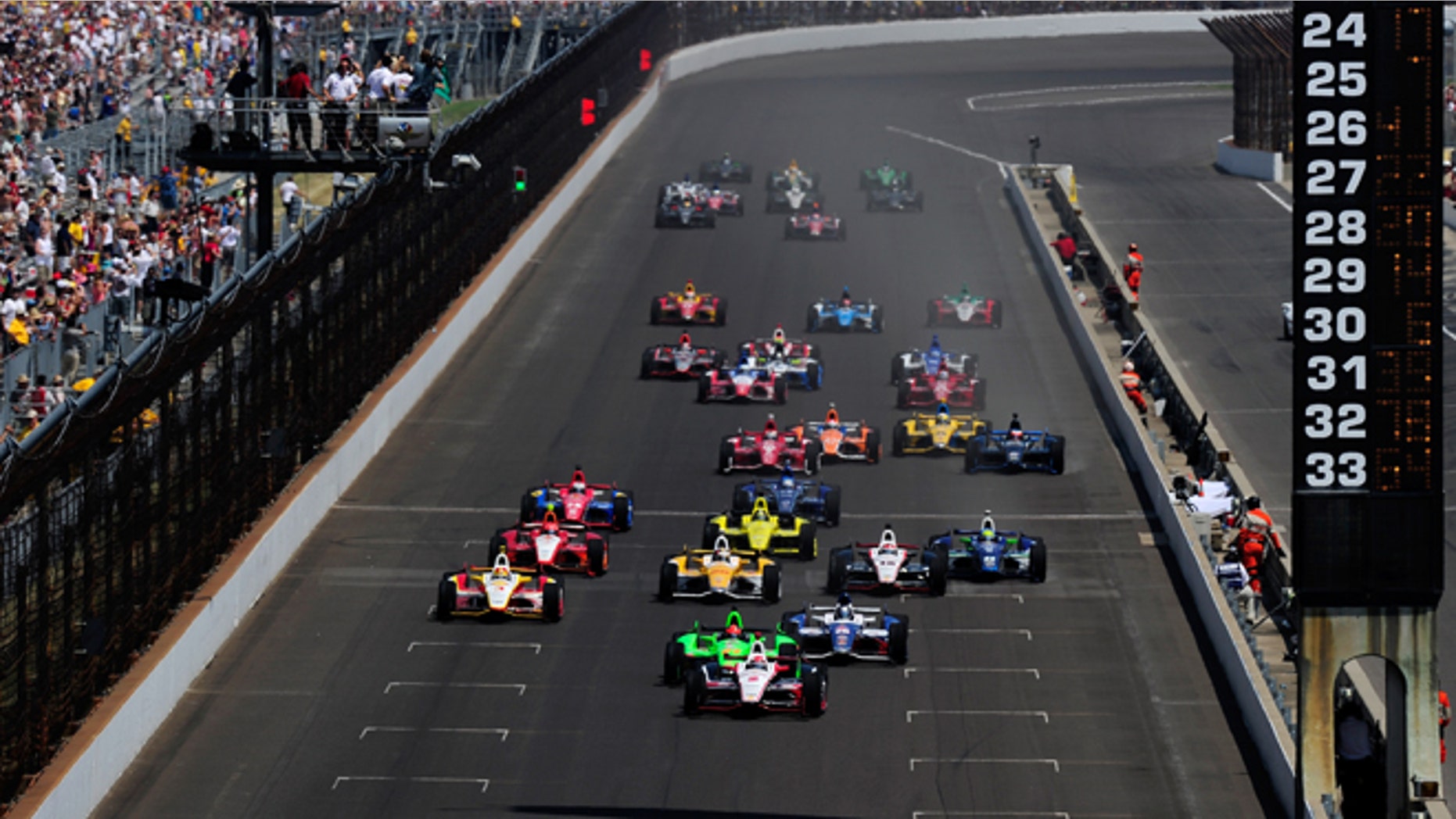 INDIANAPOLIS, IN - MAY 27: Ryan Brisco2, driver of the #2 IZOD Team Penske Chevrolet, leads the field at the start of the IZOD IndyCar Series 96th running of the Indianapolis 500 mile race at the Indianapolis Motor Speedway on May 27, 2012 in Indianapolis, Indiana. (Photo by Robert Laberge/Getty Images)