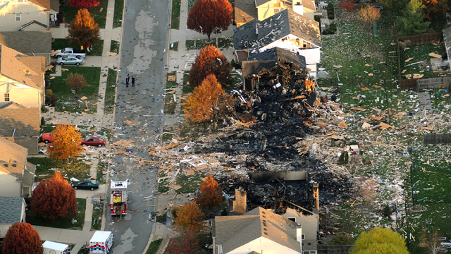 FILE - In this Nov. 11, 2012 file aerial photo are the two homes that were leveled and the neighboring homes that were damaged by a massive explosion in Indianapolis that sparked a huge fire and killed two people living in the neighborhood. On Tuesday, July 14, 2015, a jury convicted Mark Leonard of murder, arson and insurance fraud for his role in the explosion that devastated the subdivision. (AP Photo/The Indianapolis Star, Matt Kryger, File)