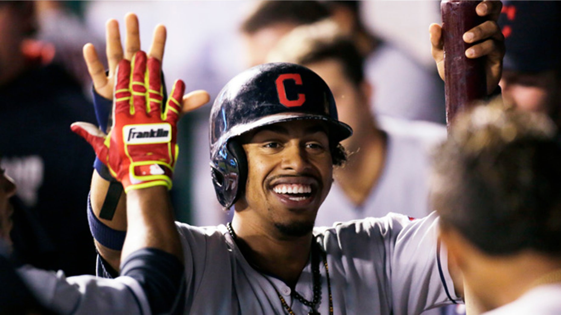 FILE - In this Sept. 30, 2016, file photo, Cleveland Indians' Francisco Lindor is congratulated in the dugout after scoring during the third inning of a baseball game against the Kansas City Royals at Kauffman Stadium in Kansas City, Mo. While most of America gushes over the Chicago Cubs and their quest at ending a 108-year World Series drought, Cleveland's taking aim at its own championship dryspell following a season in which the Indians overcame numerous obstacles and outclassed the AL Central. (AP Photo/Colin E. Braley, File)
