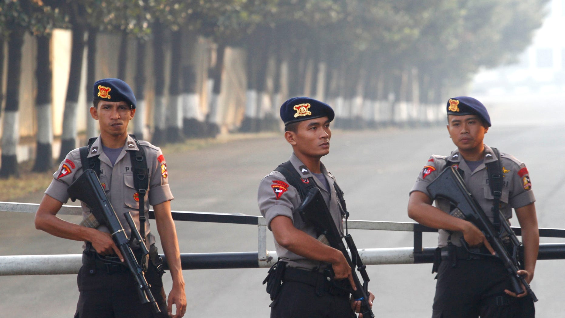 August 11: Armed officers man a checkpoint at the gate of a police compound where Indonesian militant, Umar Patek, is detained on the outskirts of Jakarta, Indonesia. Patek, who allegedly made the explosives used in the 2002 Bali bombings, returned to his homeland under tight security more than six months after he was captured in northwest Pakistan, officials said.