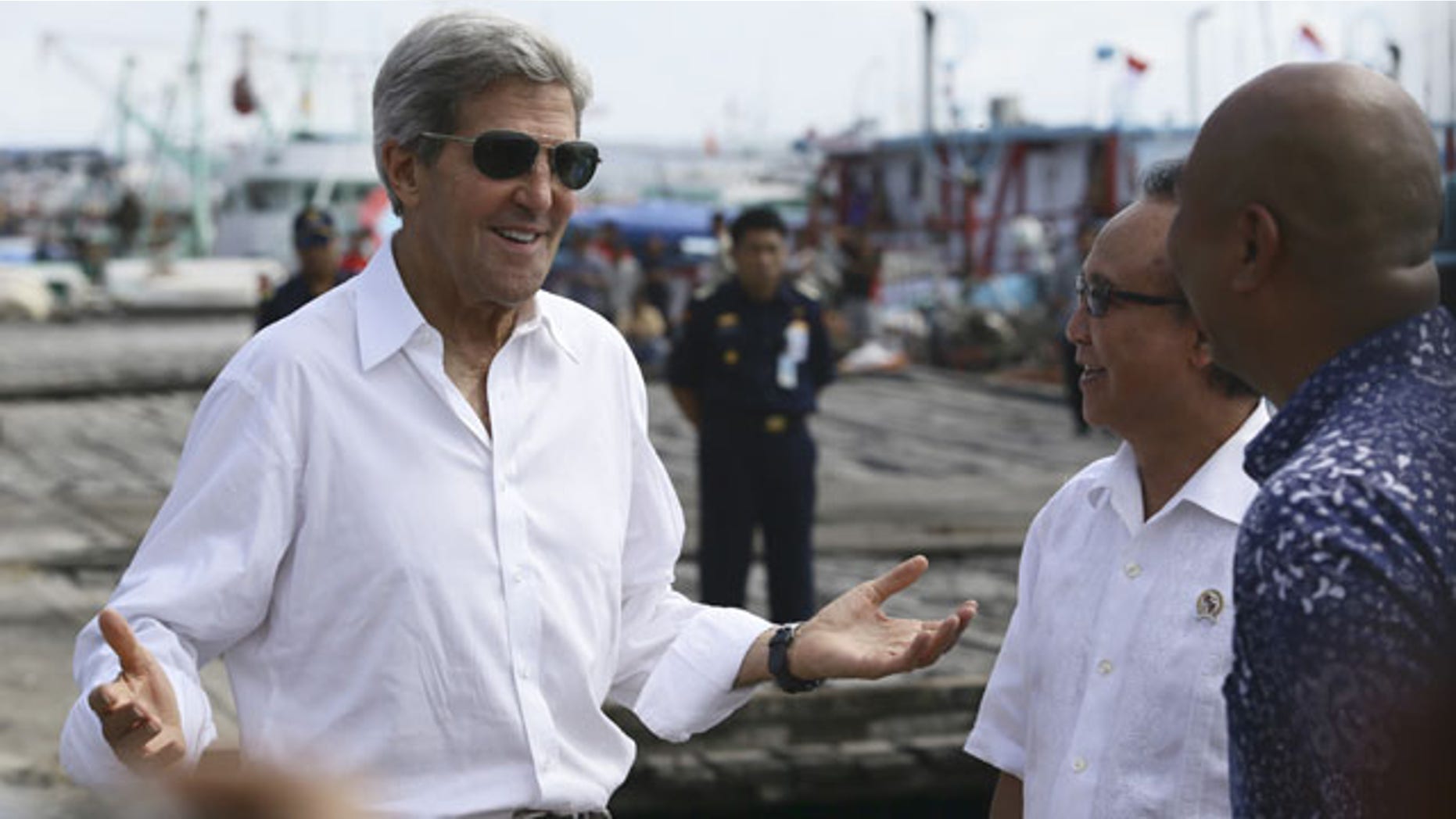 October 6, 2013: U.S. Secretary of State John Kerry speaks to officials during a visit to a tuna packaging factory in Bali, Indonesia. (AP Photo)