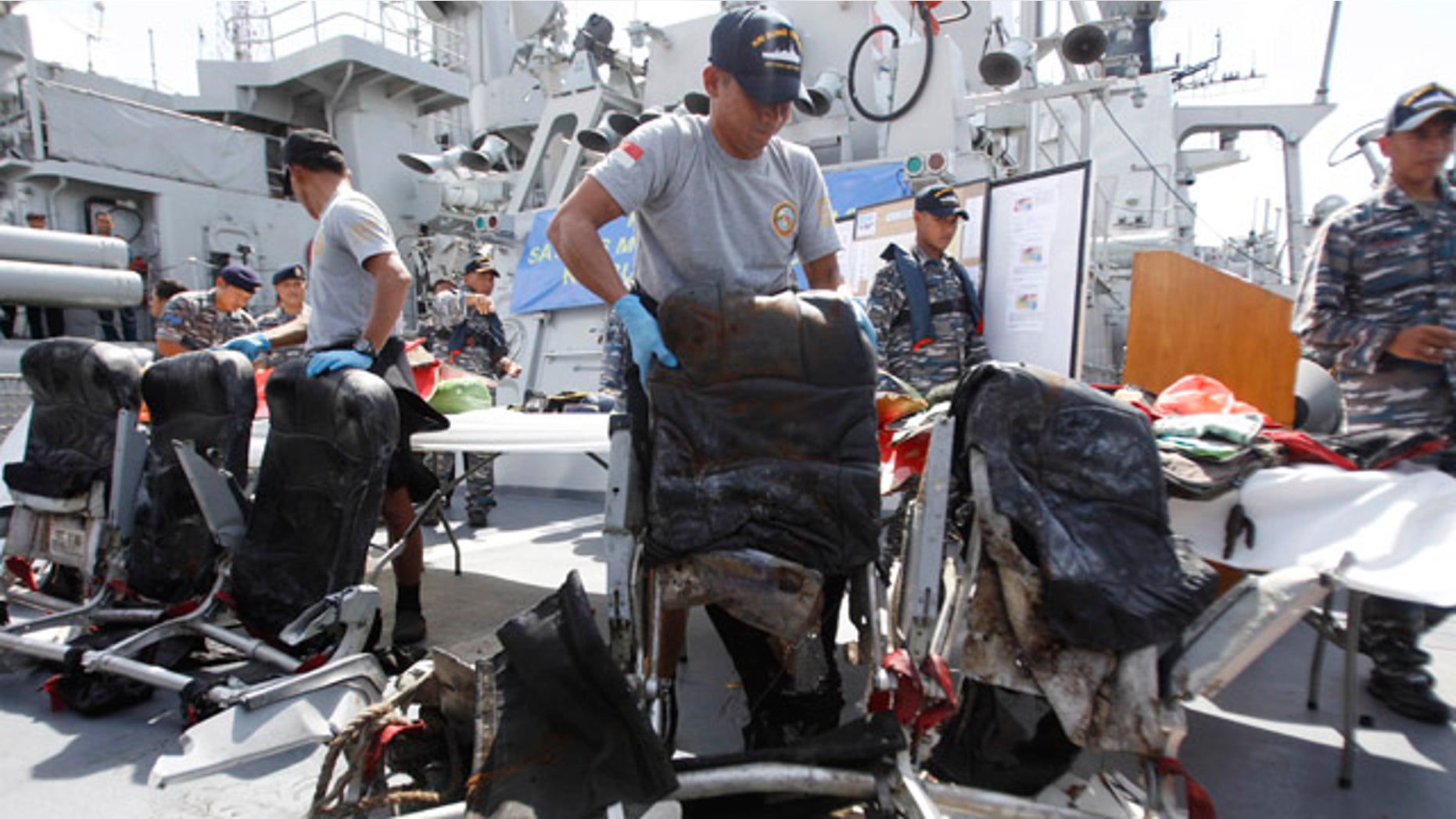Jan. 5, 2015: Crew members of Indonesian Navy ship KRI Bung Tomo show airplane seats from AirAsia Flight 8501 recovered during search operations for the ill-fated jetliner during a press conference at the Navy's Eastern Fleet Naval Base in Surabaya, East Java. (AP Photo/Trisnadi)