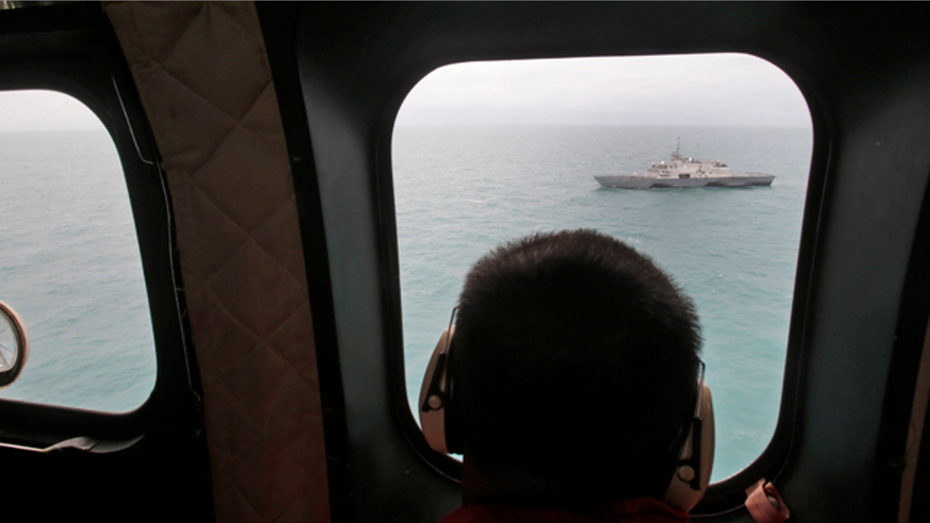 Jan. 6, 2015: A military ship is seen from Indonesian Air Force NAS 332 Super Puma helicopter during a search operation for the victims of AirAsia Flight 8501, off Pangkalan Bun, Central Borneo. (AP Photo/Achmad Ibrahim, Pool)