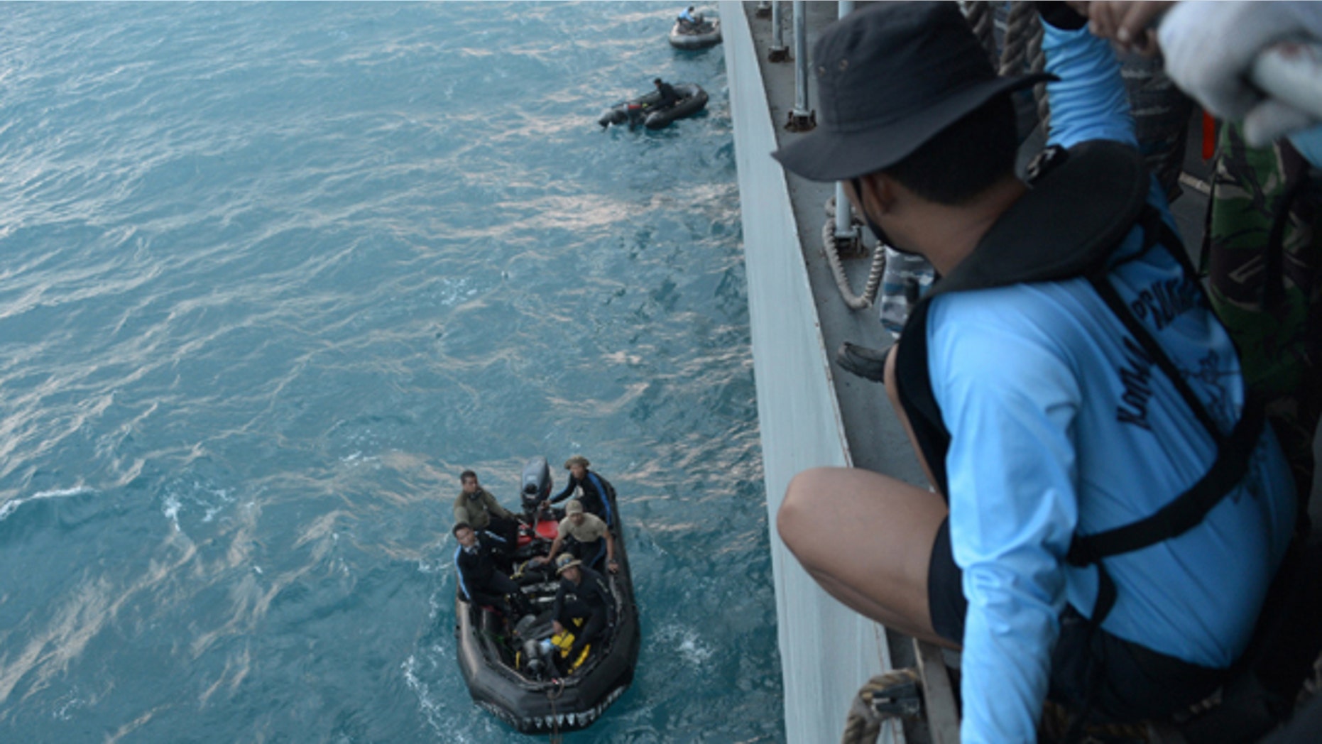 Jan. 9, 2015: Indonesian navy divers prepare operations to lift the tail of AirAsia Flight 8501 in the Java Sea. (AP Photo/Adek Berry, Pool)