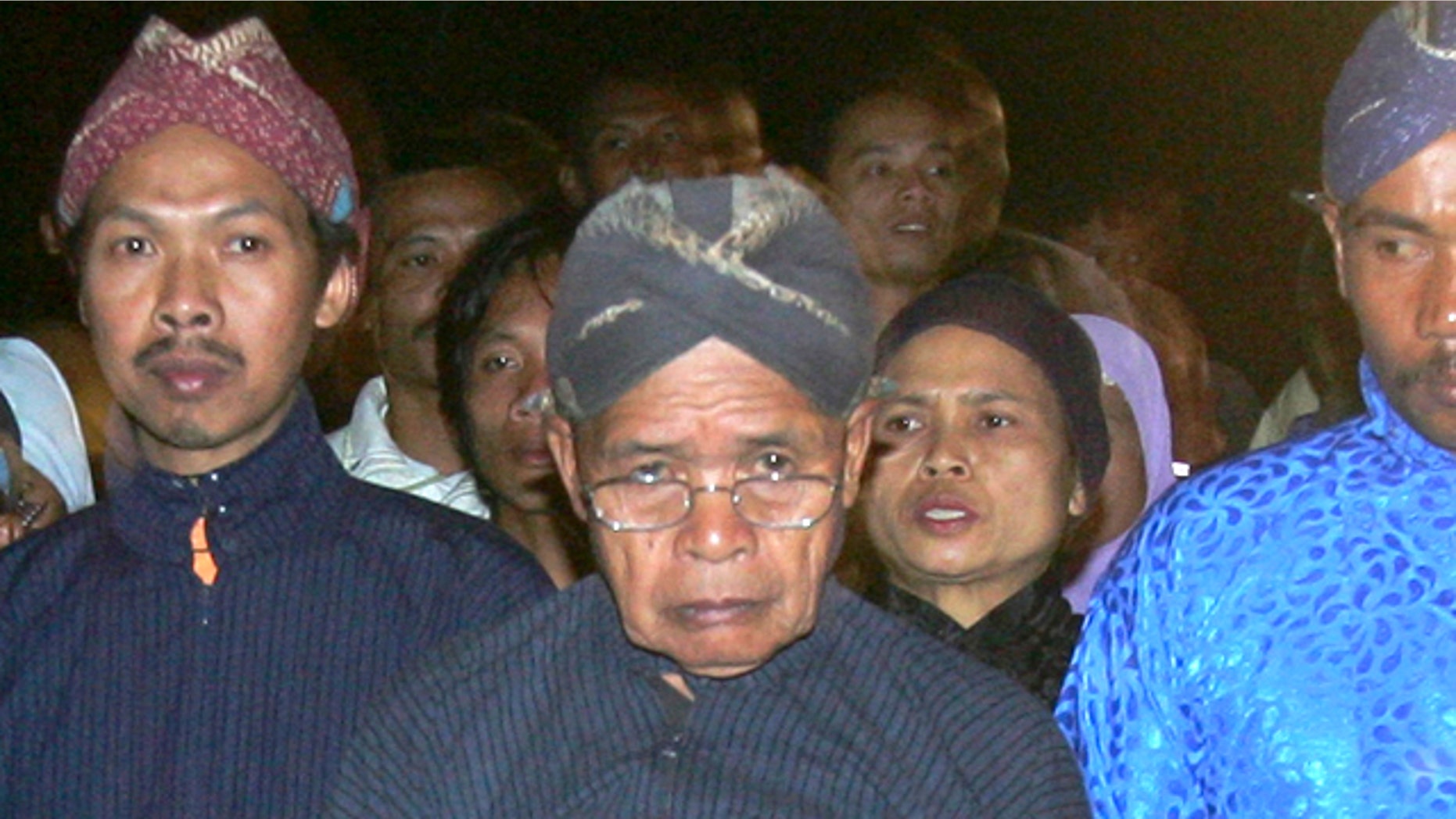 Maridjan (center), the spiritual guardian of Mount Merapi, performas a midnight walk in silence with other villagers in this 2006 photo. For 33 years, Maridjan spoke to Mount Merapi, appeasing its unpredictable spirits by offering of rice, clothes and chickens to the volcano that recently took his life.