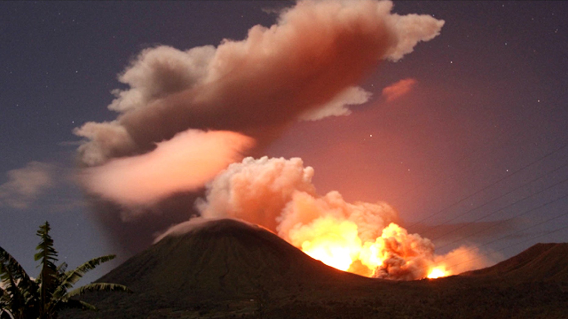 July 14, 2011: The glow of lava from Mount Lokon's eruption is seen against the night sky from Tomohon, North Sulawesi, Indonesia.