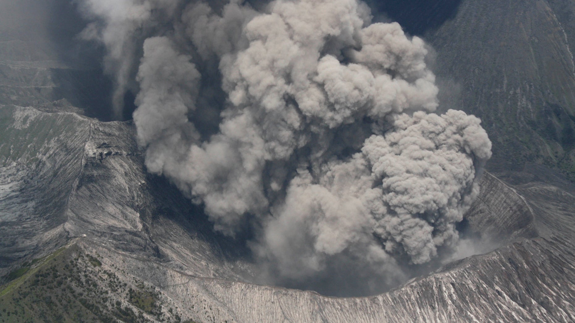 Mount Bromo spews volcanic materials as it erupts in this aerial shot taken from an Indonesian Air Force airplane that flies over Probolinggo, East Java, Indonesia on Monday, Nov. 29, 2010. The smoking volcano on Indonesia's main island has forced the closure of a local airport after it came back to life last week following a yearlong lull.