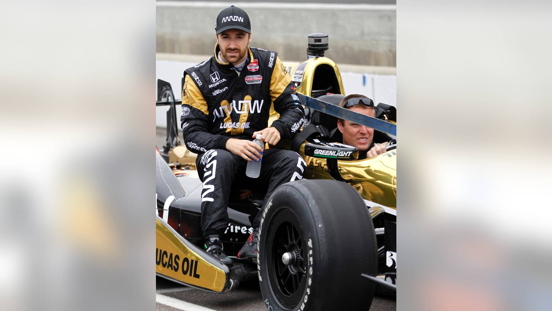 FILE - In this May 16, 2015, file photo, James Hinchcliffe, of Canada, rides on his car out to the pit area during practice on the first day of qualifications for the Indianapolis 500 auto race at Indianapolis Motor Speedway in Indianapolis. Hinchcliffe jokes that he received "a complete oil change" after his accident during preparations for the Indianapolis 500. All kidding aside, the IndyCar driver recognizes he's very lucky to be alive. Hinchcliffe suffered a life-threatening leg injury May 18 when a piece of his suspension broke during a crash and pierced his leg. (AP Photo/AJ Mast, File)