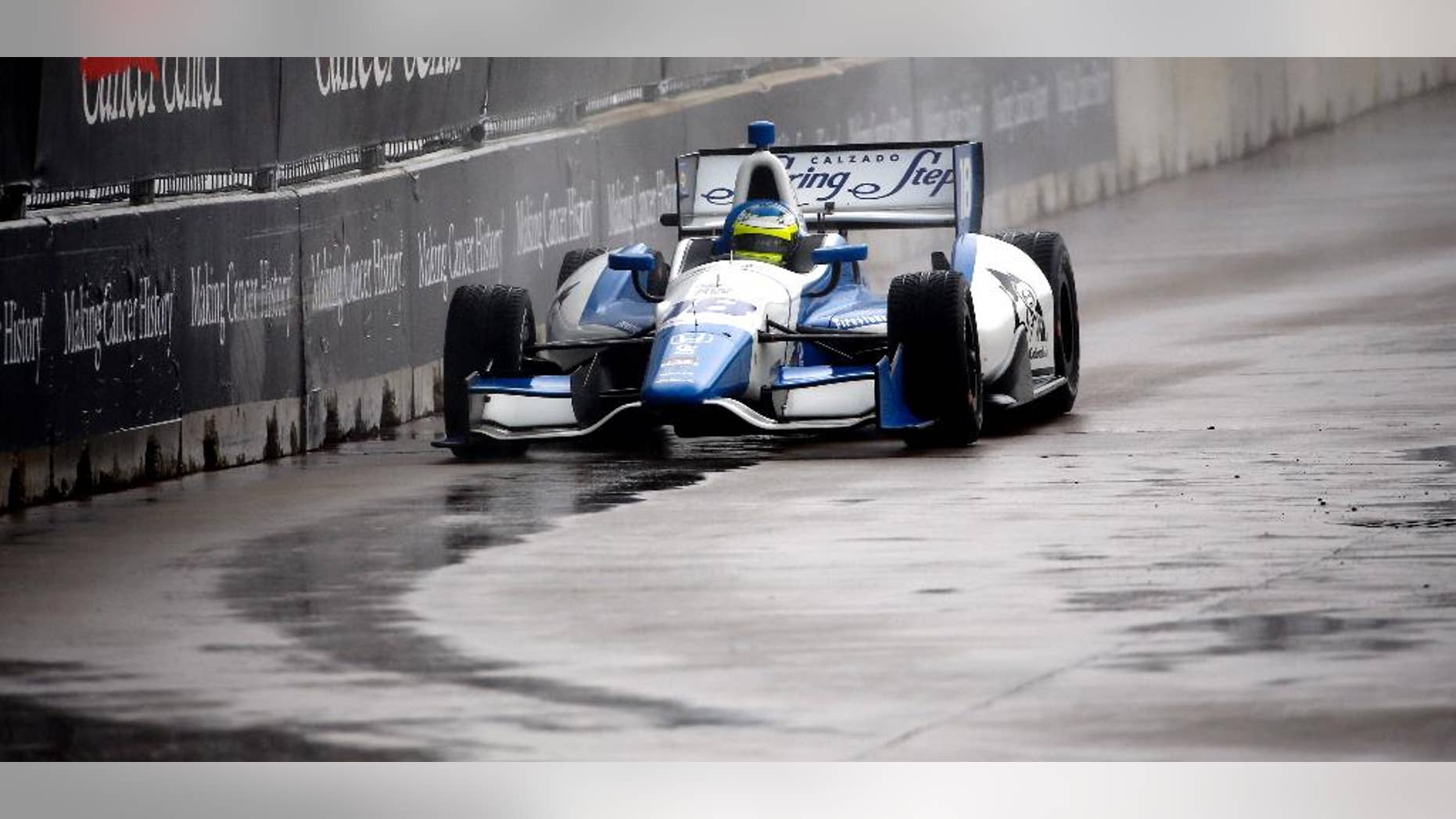 Carlos Huetas (18), of Colombia, drives into Turn 3 during the first of two IndyCar Grand Prix of Houston auto races Saturday, June 28, 2014, in Houston. Huetas won the race. (AP Photo/David J. Phillip)