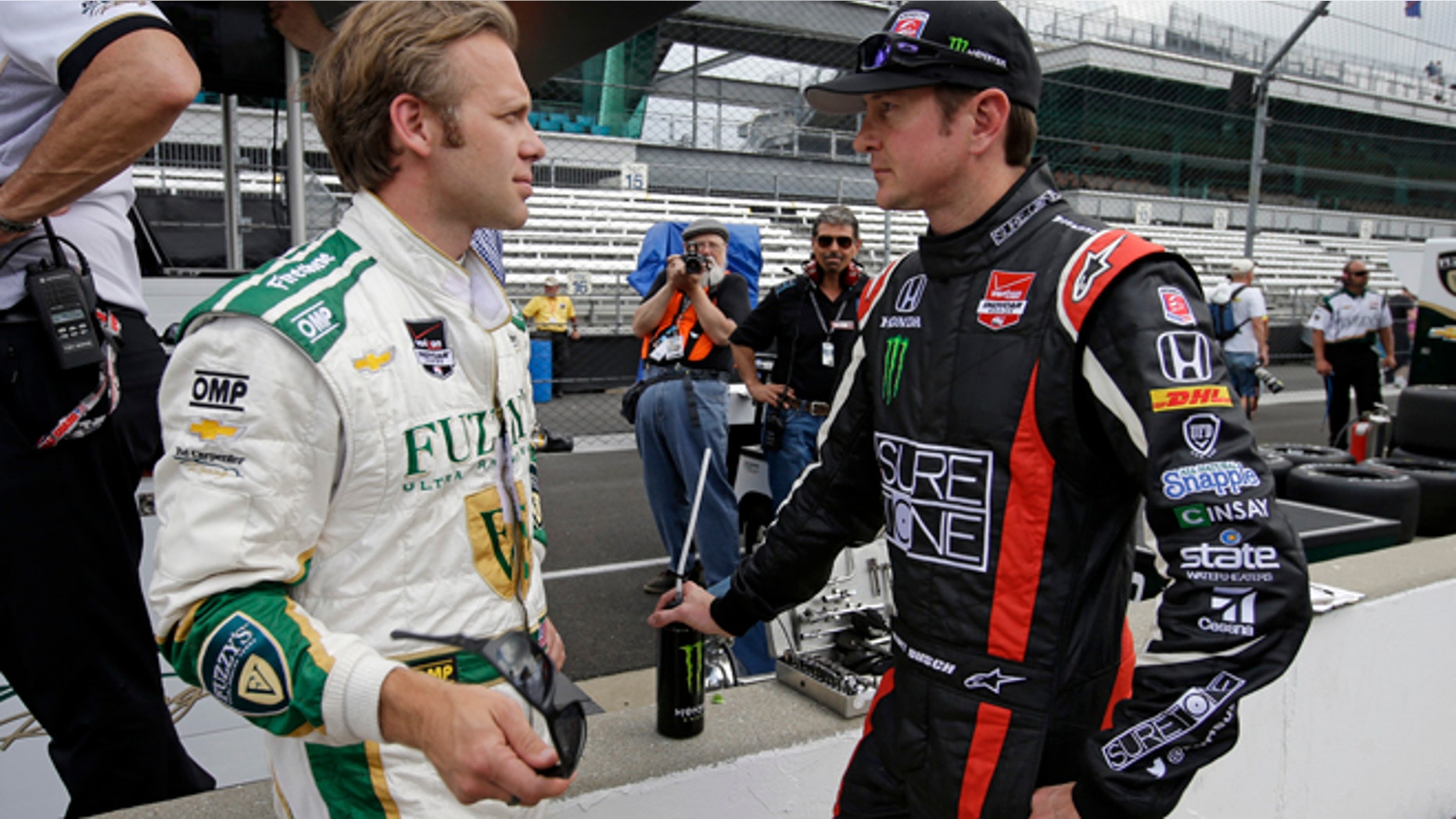 May 11, 2014: Kurt Busch, right, talks with Ed Carpenter during practice for Indianapolis 500 IndyCar auto race at the Indianapolis Motor Speedway in Indianapolis. (AP)