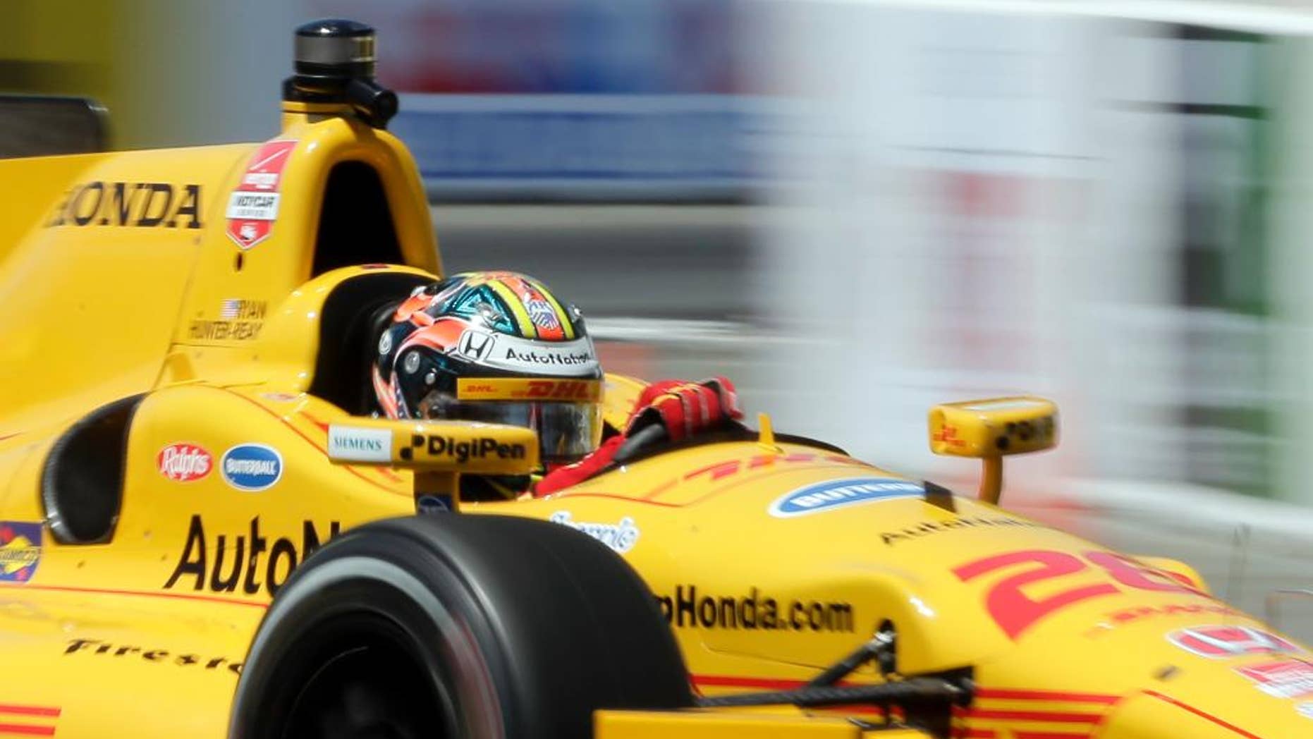 FILE - In this April 17, 2015, file photo, Ryan Hunter-Reay drives during a practice run for the IndyCar race at the Toyota Grand Prix of Long Beach in Long Beach, Calif. The two-time defending race champion returns to Alabama this weekend after a rough start that included a penalty from IndyCar with which he adamantly disagrees. (AP Photo/Chris Carlson, File)