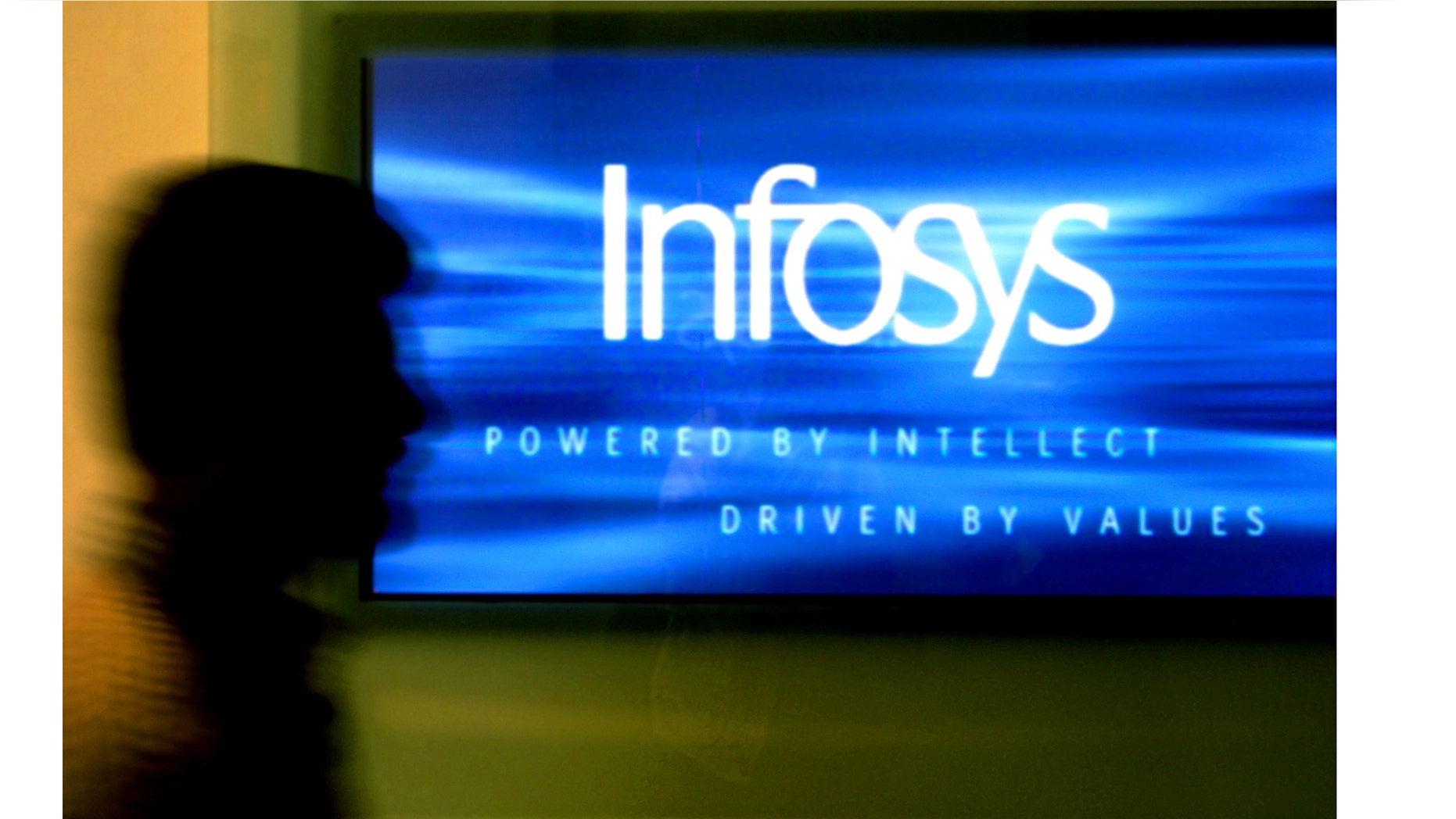 A man walks past a billboard of Infosys Technologies Ltd's office inBangalore, capital of the southern state of Karnataka, October 10,2003. Infosys reported on Friday its quarterly earnings rose 33 percenton the global boom in outsourcing and raised its profit forecast.REUTERS/Jagadeesh NVKK/FA