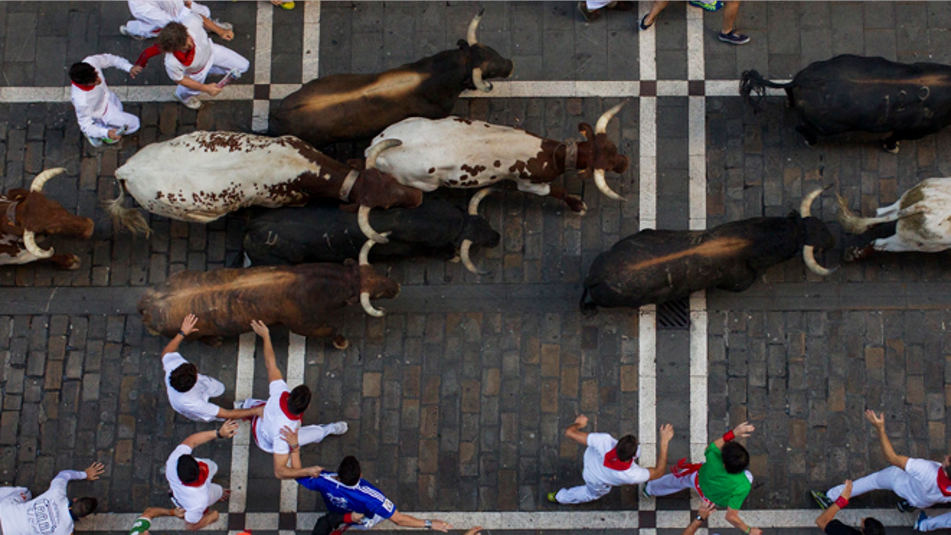 Victoriano del Rio fighting bulls run after revelers during the running of the bulls at the San Fermin festival in Pamplona, Spain, Thursday, July 9, 2015. Revelers from around the world arrive in Pamplona every year to take part in some of the eight days of the running of the bulls. (AP Photo/Andres Kudacki)