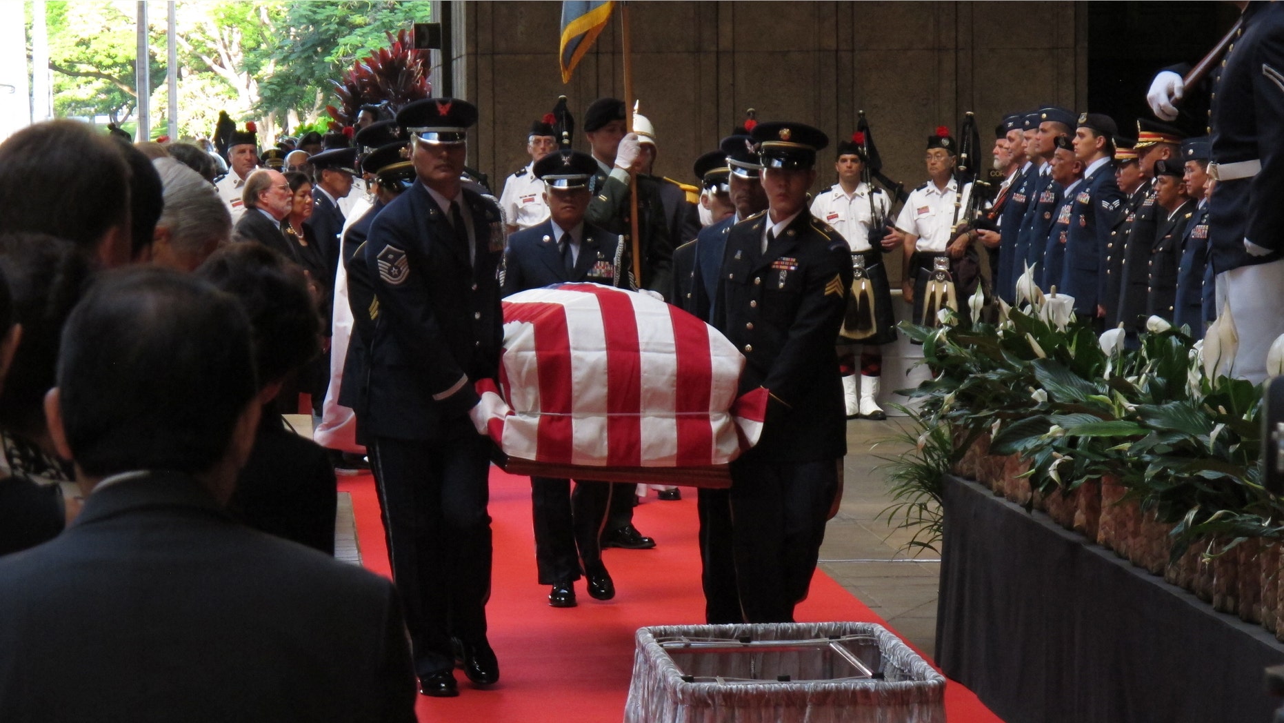 Saturday, Dec. 22, 2012: Pallbearers carry the casket of Sen. Daniel Inouye into the courtyard of the Hawaii state Capitol during a visitation ceremony in Honolulu.