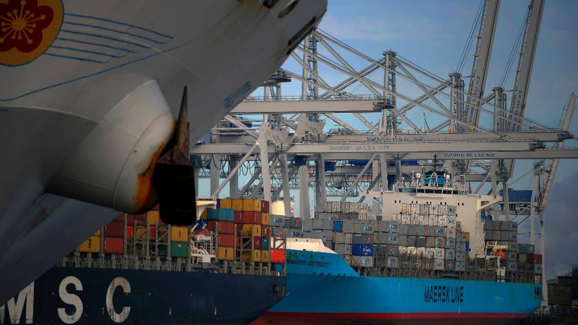 FILE - In this Monday, Jan. 27, 2014, file photo, shipping containers prepare to be loaded and unloaded at the Georgia Ports Authority Garden City terminal, in Savannah, Ga. The commerce department releases international trade data for January, on Friday, March 7, 2014. (AP Photo/Stephen B. Morton)