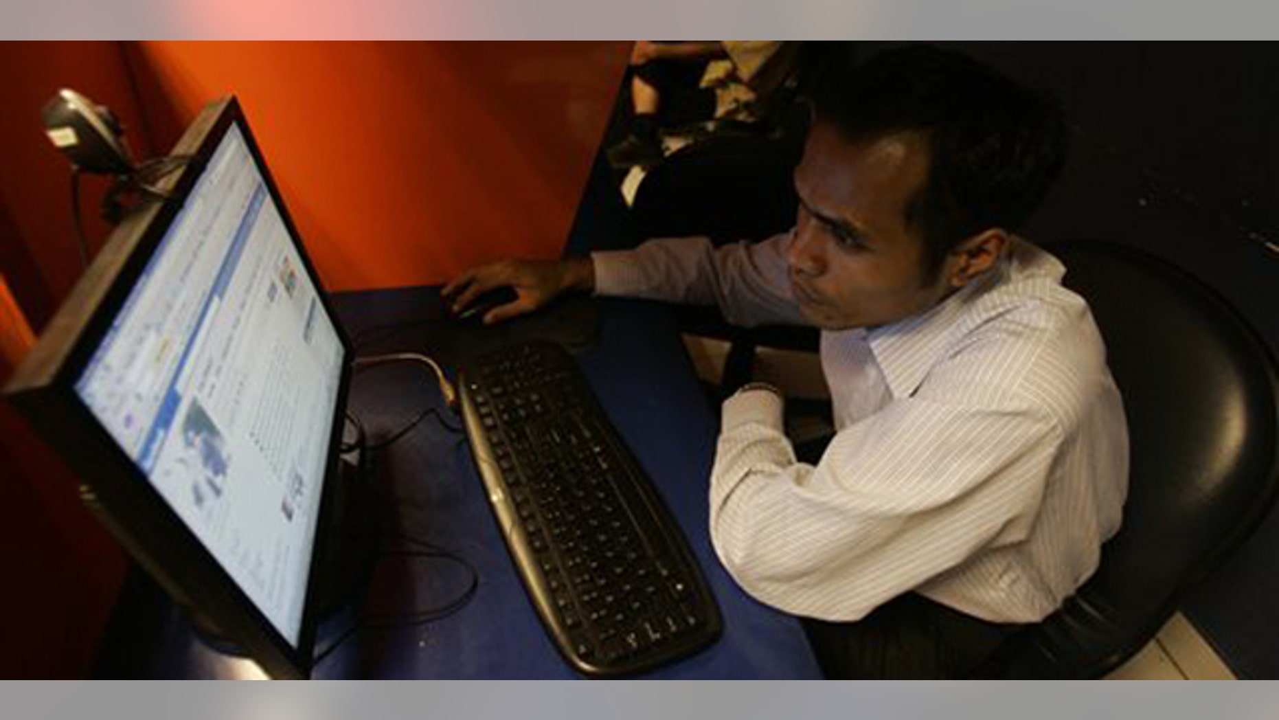 An Indonesian man checks his Facebook page at an Internet cafe in Jakarta, Indonesia, Wednesday, Feb. 17, 2010. A teenager received a suspended jail sentence for posting insulting comments on a romantic rival's Facebook page, the latest case bringing Indonesia's tough defamation laws under criticism. (AP Photo/Irwin Fedriansyah)