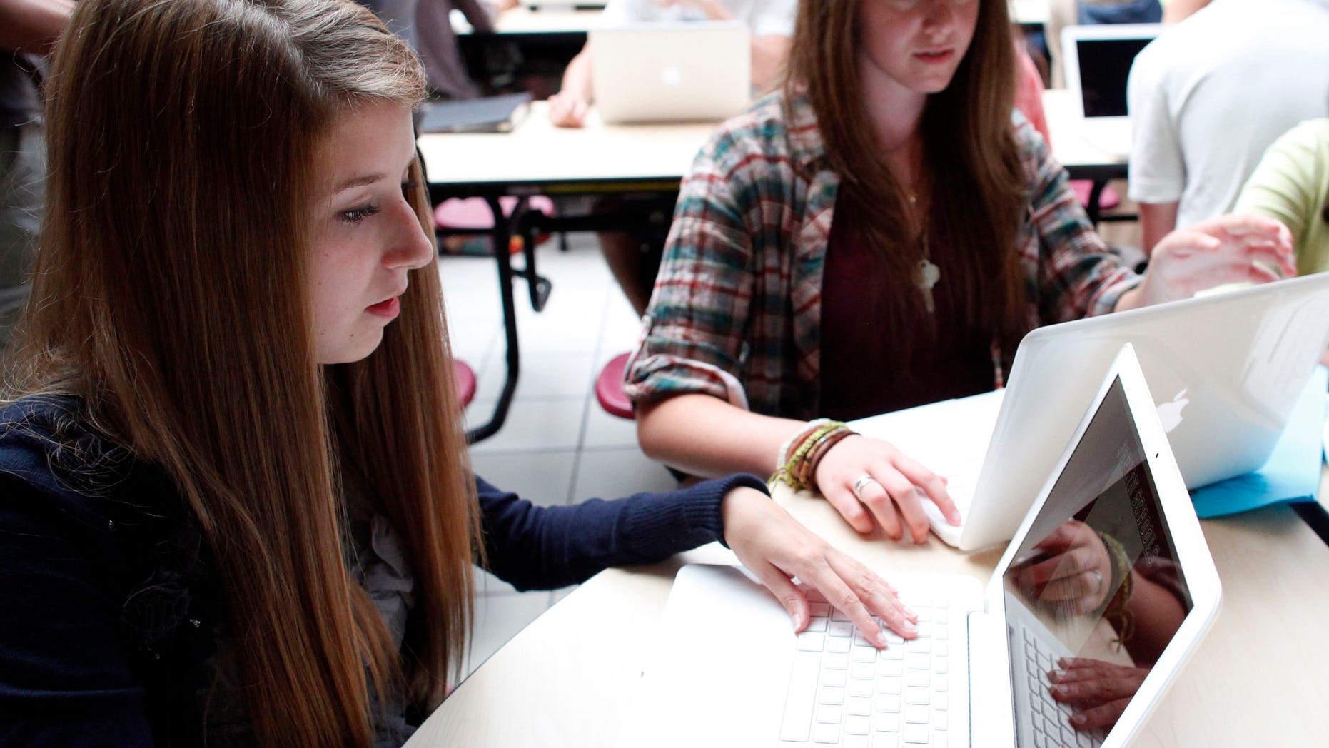 FILE: Aug. 17, 2011: Students with laptops at Joplin High School in Joplin, Missouri.