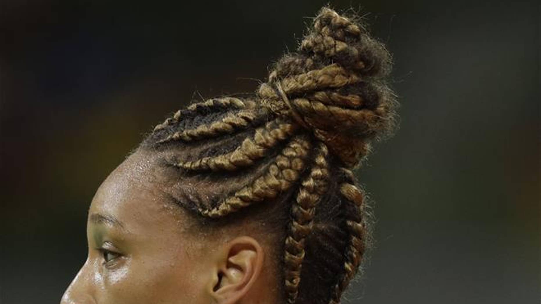 France's Beatrice Edwige wears her hair in braids during the women's preliminary handball match between South Korea and France at the 2016 Summer Olympics in Rio de Janeiro on Aug. 12, 2016.