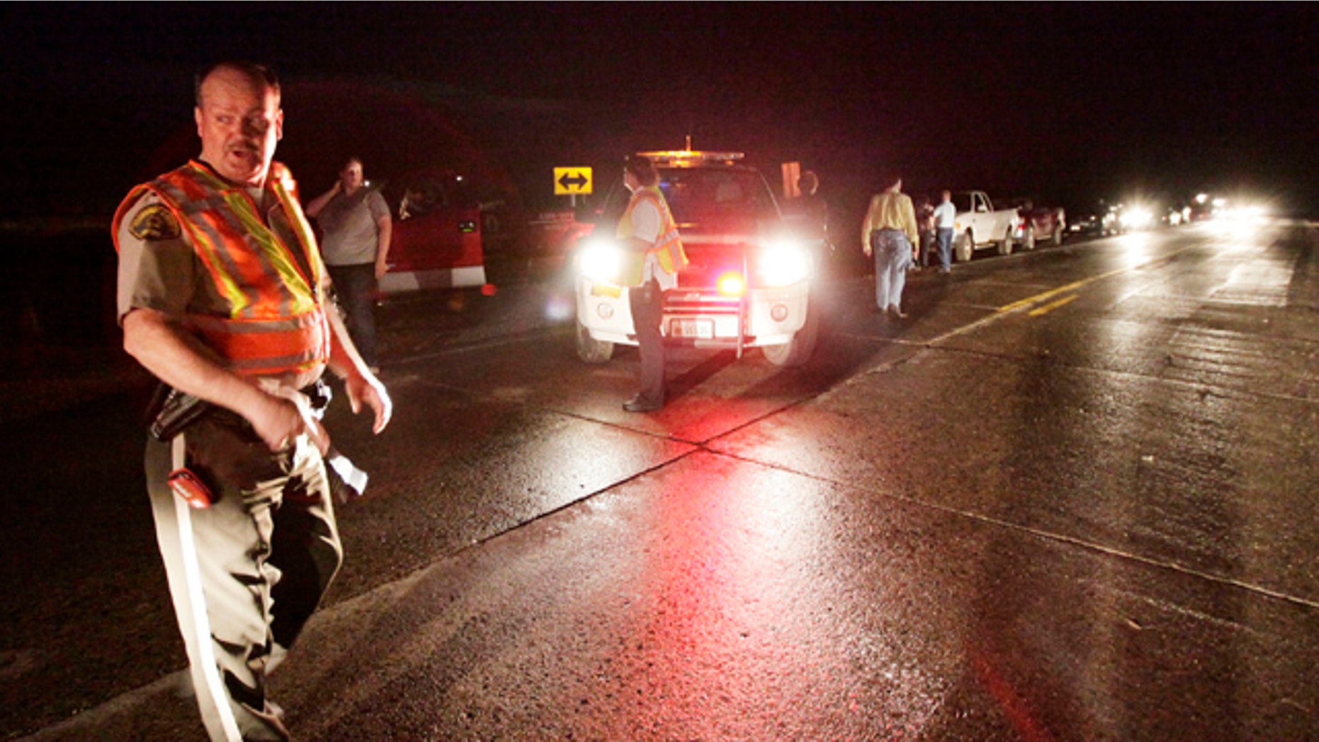April 9, 2011: A Sheriff's deputy blocks off the intersection of Highways 141 and 175 preventing people from entering Mapleton, Iowa after a tornado struck the town.A