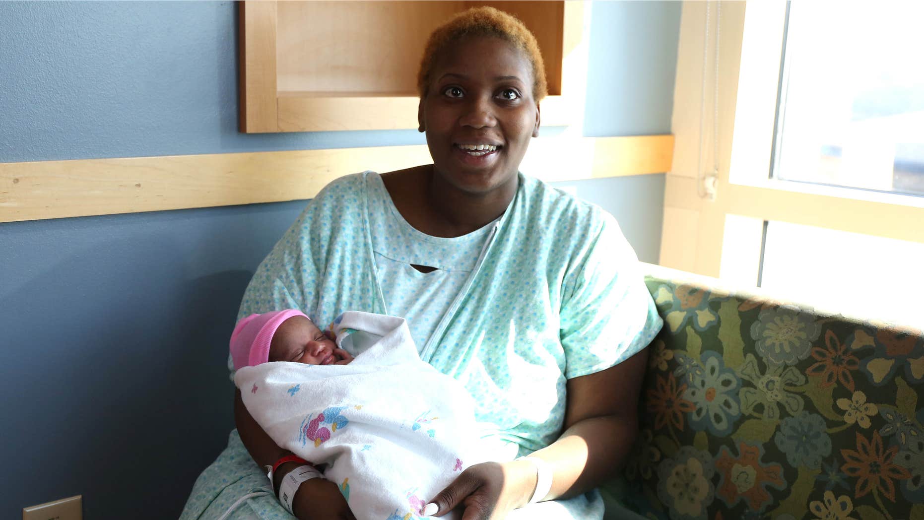 March 11, 2015: Brittany Young, 24, of Des Moines, Iowa, with her newborn baby Miracle.