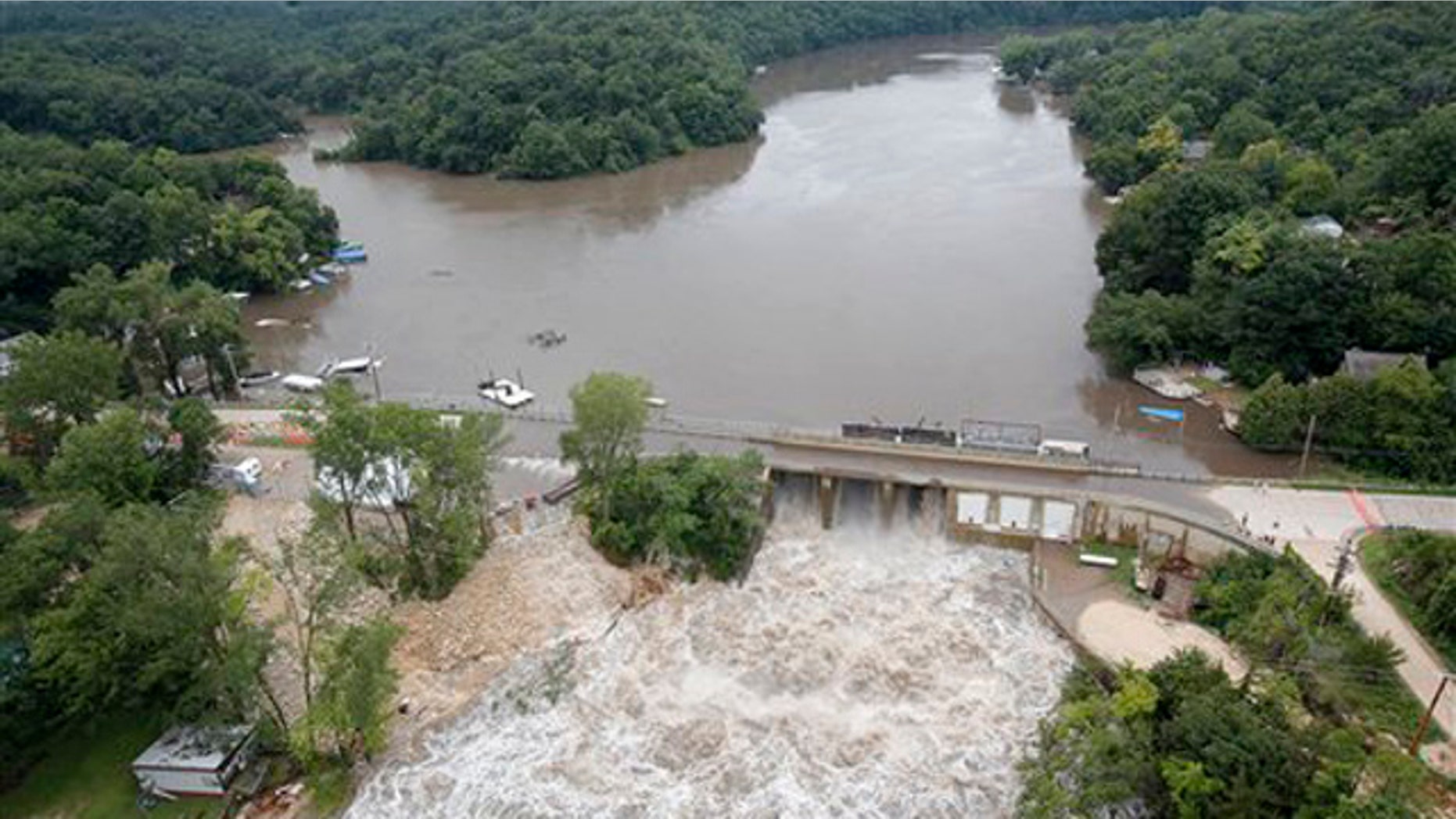July 24, 2010: Maquoketa River water surges over the bridge of the Delhi Dam as areas surrounding the Maquoketa River continue to flood.