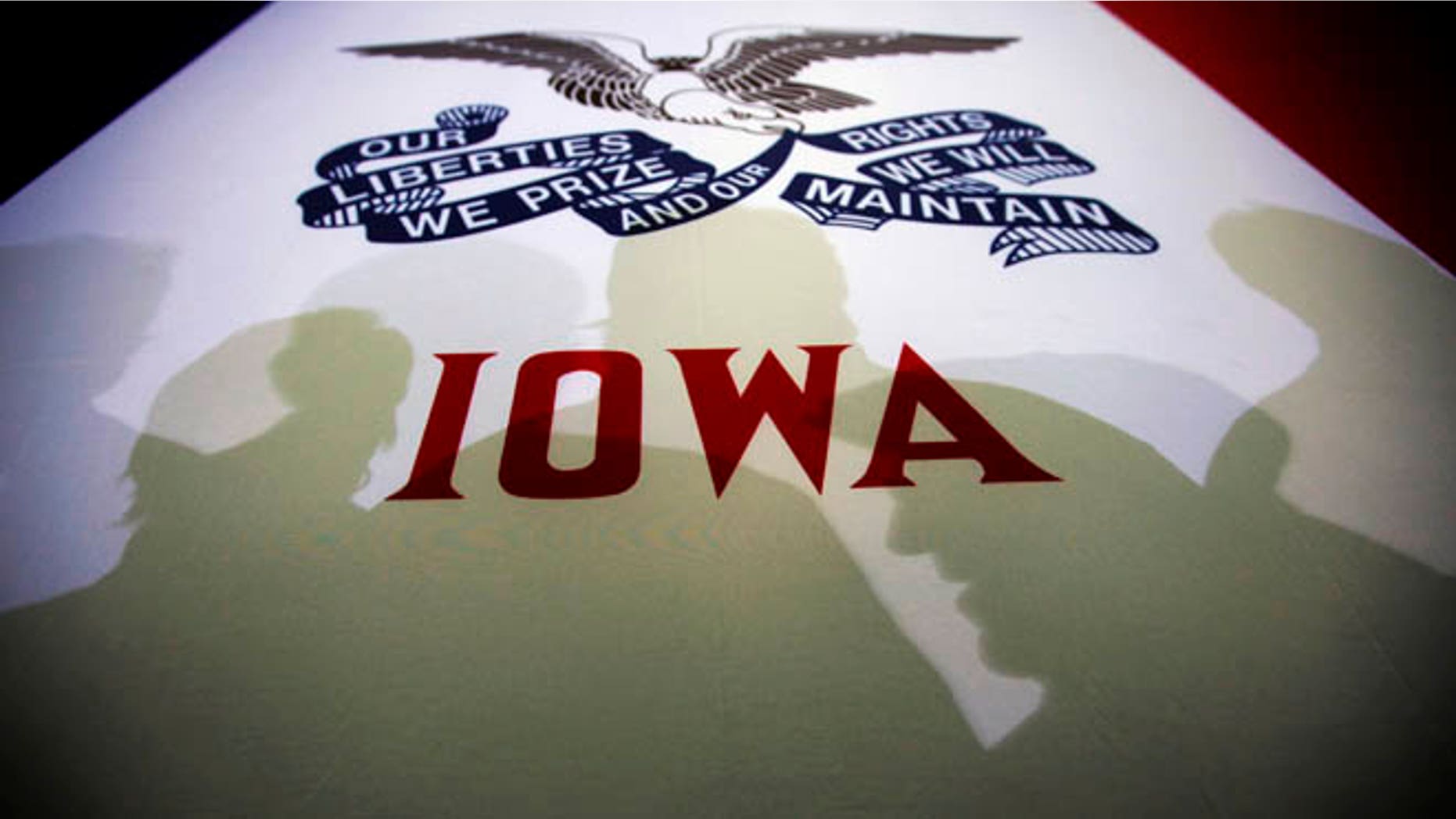 FILE: January 2, 2012: Potential caucus voters cast shadows on an Iowa state flag at a GOP campaign rally, Clive, Iowa.