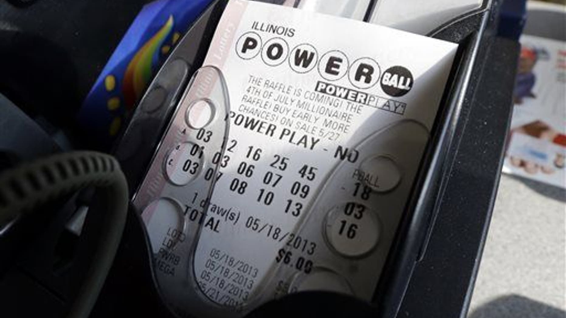A Powerball lottery ticket is printed out of a lottery machine at a convenience store in Illinois.