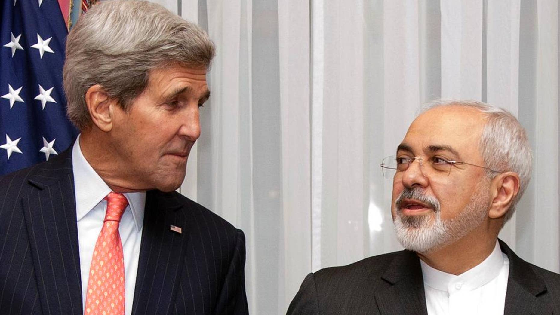FILE - In this March 16, 2015 file photo U.S. Secretary of State John Kerry, left, listens to Iran's Foreign Minister Mohammad Javad Zarif, right, before resuming talks over Iran's nuclear program in Lausanne, Switzerland. As negotiators prepare to start drafting a final deal to curb Iran's atomic activities, conflicting U.S.-Iran takes on key elements mean tough work ahead of a June 30 deadline. Though six world powers remain at the bargaining table, the real negotiating is between the two nations. (Brian Snyder/Pool Photo via AP, File)