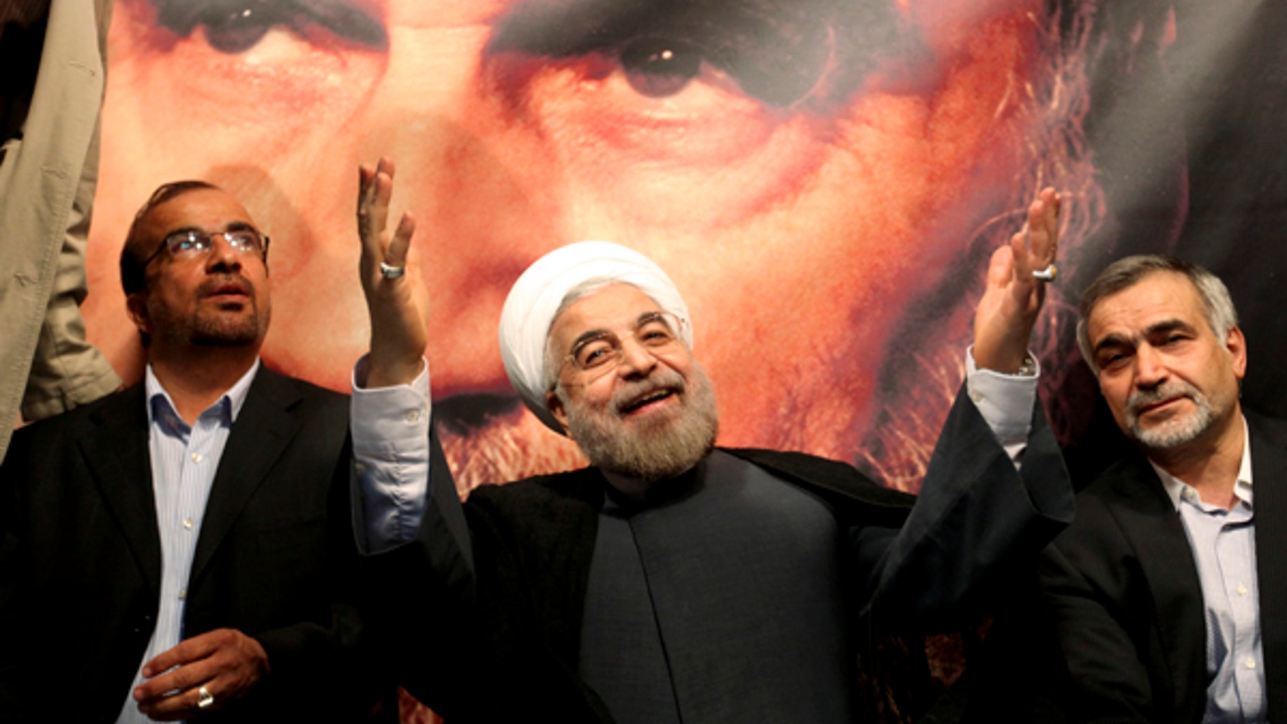 June 1, 2013: This photo shows, in front of a portrait of the late Iranian revolutionary founder Ayatollah Khomeini, presidential candidate Hasan Rowhani, a former top nuclear negotiator, center, gestures to his supporters at a rally in Tehran, Iran. Iranian pro-reform candidate, Mohammad Reza Aref, pulled out of this week's presidential election to give support to a centrist whose campaign has gained momentum in recent days. The decision by Aref is seen as a major boost for Hasan Rowhani, who now faces off against five conservative candidates Friday.
