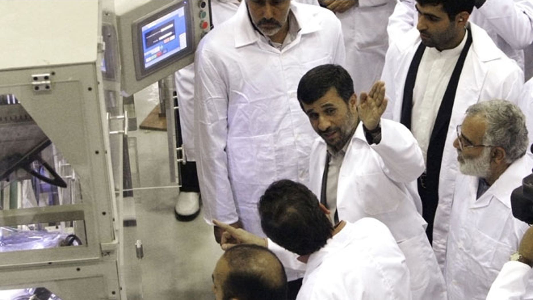 April 9, 2009: Iranian President Mahmoud Ahmadinejad, second right, gestures, as he visits Iran's Fuel Manufacturing Plant (FMP), a new facility producing uranium fuel for a planned heavy-water nuclear reactor, just outside the city of Isfahan, 255 miles south of Tehran, Iran.