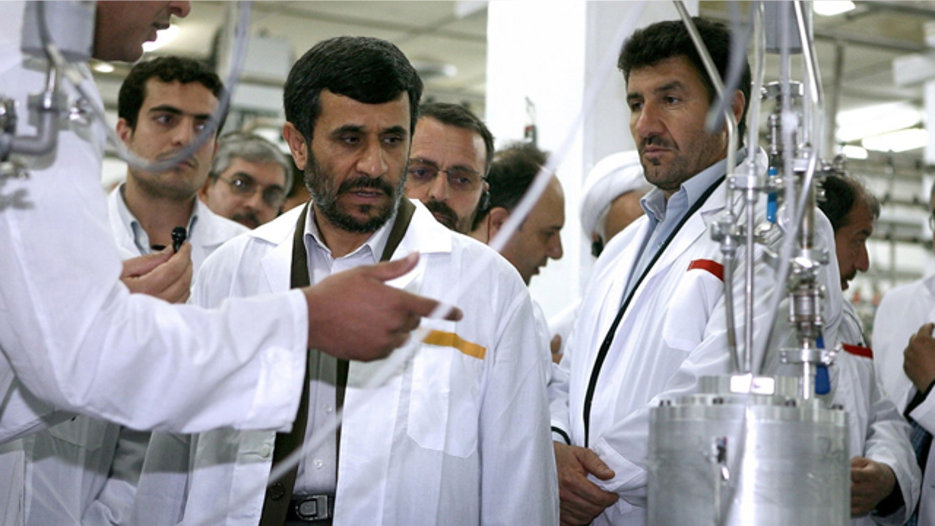 FILE: April 2008: President Mahmoud Ahmadinejad listens to a technician during his visit of the Natanz Uranium Enrichment Facility.