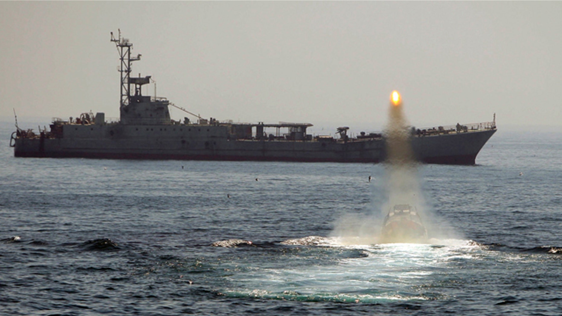 April 2010: An Iranian warship and speed boats take part in a naval war game in the Persian Gulf and the Strait of Hormuz, southern Iran.