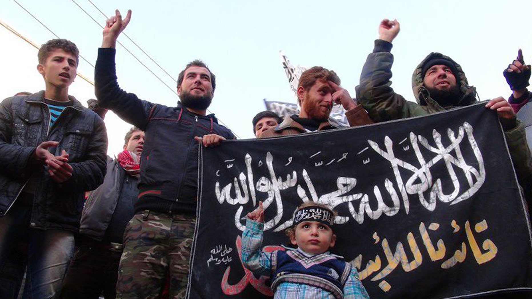Jan. 25, 2013: This citizen journalism image provided by Edlib News Network, ENN, which has been authenticated based on its contents and other AP reporting, shows Syrians chanting slogans and holding an Islamic banner during a demonstration after Friday prayer, at Binnish village in Idlib province, north Syria.