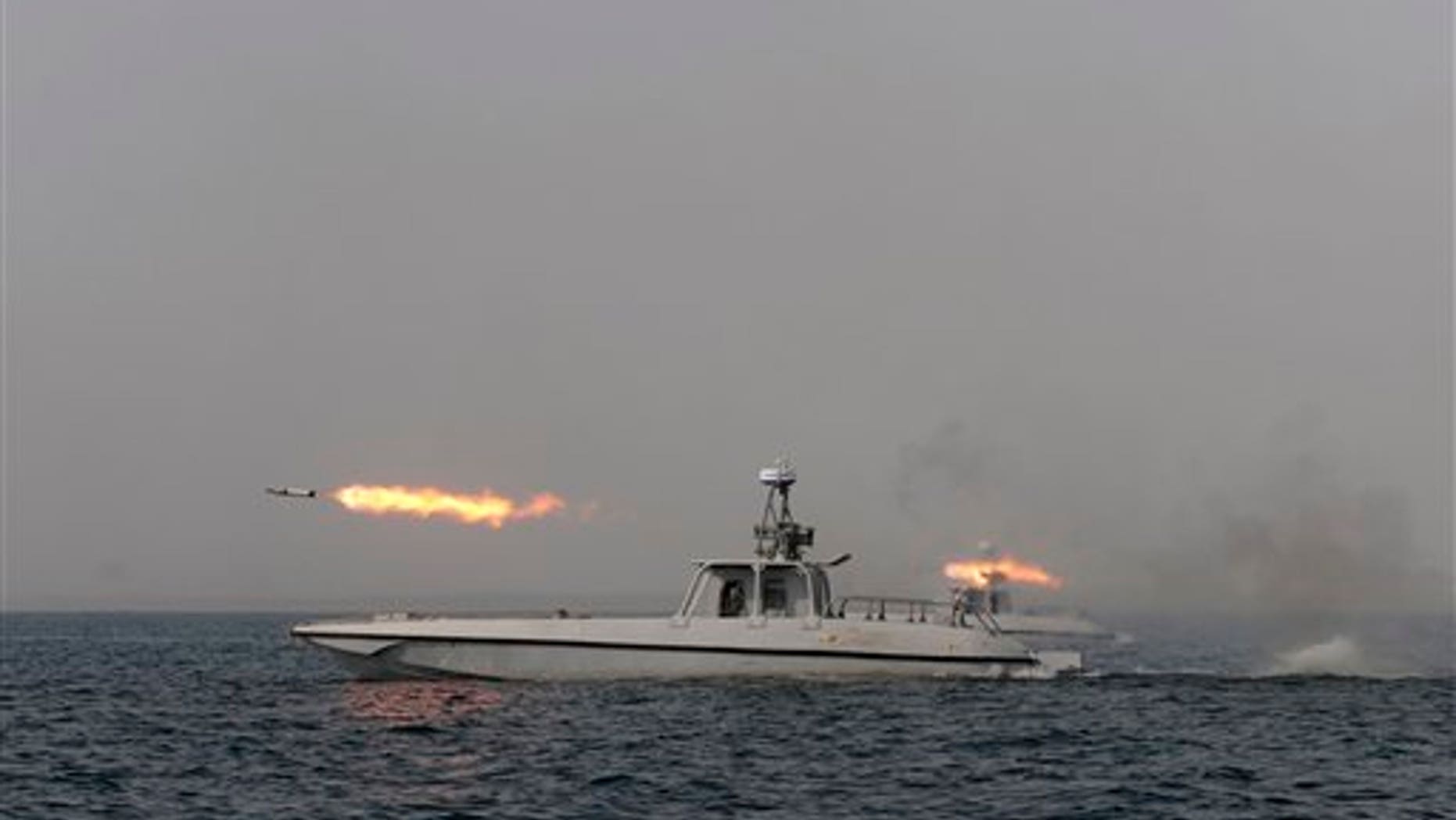 Dec. 30, 2011: An Iranian navy boat fires a missile in a drill in the sea of Oman.