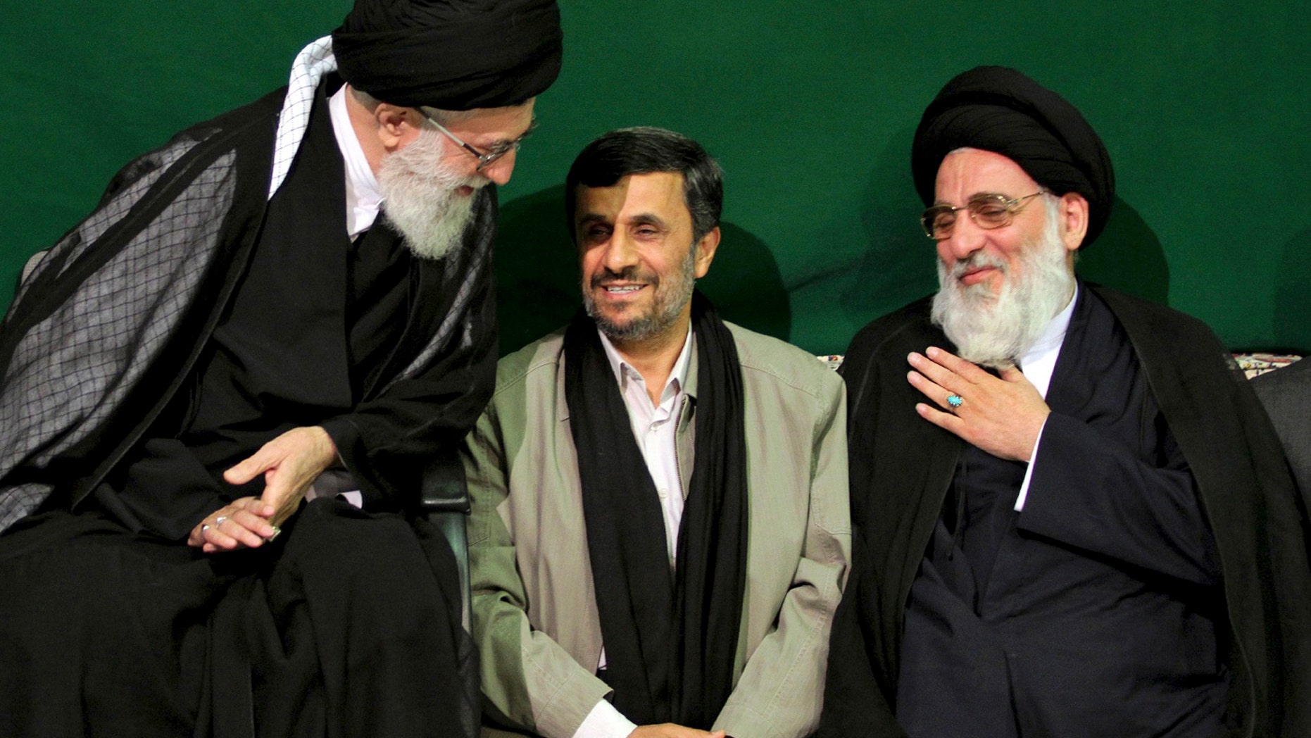 In this Saturday, May 7, 2011 photo released by an official website of the Iranian supreme leader's office, Iranian supreme leader Ayatollah Ali Khamenei, left, greets former Judiciary chief Ayatollah Mahmoud Hashemi Shahroudi, right, as President Mahmoud Ahmadinejad sits at center, during a religious ceremony, in Tehran, Iran. (AP)