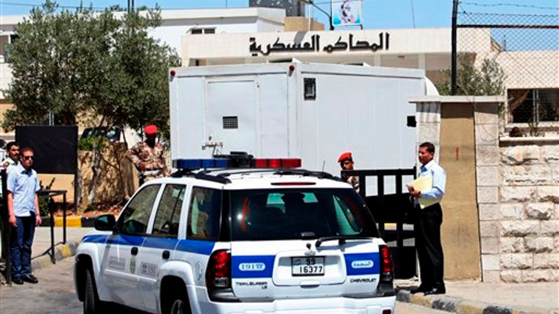 July 28: A prison van carrying Sheik Abu-Mohammed al-Maqdisi is escorted by police vehicles to a military court in Amman, Jordan.