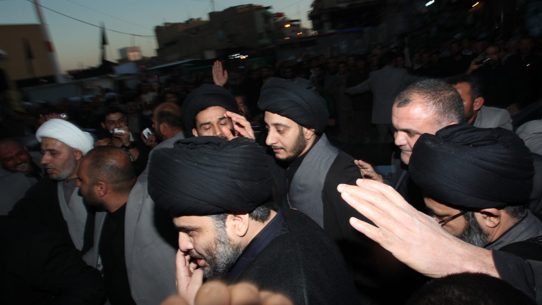 Jan. 5: Anti-American cleric Muqtada al-Sadr, center, is surrounded by supporters in the Shiite city of Najaf, Iraq. Muqtada al-Sadr has returned to Iraq after a nearly three-year absence.